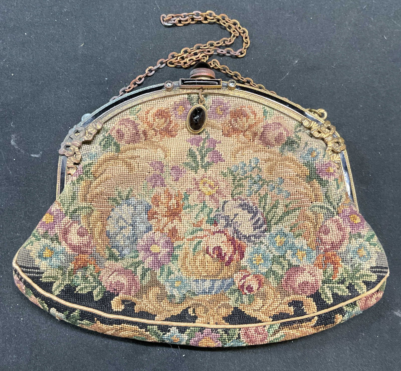 Vintage Floral Needlepoint Faux Cabochon Handbag: Vintage needlepoint handbag with faux black cabochons and floral pattern. Enameled and marcasite decorated frame. Measures approx 4 x 6 inches. Some discoloration and tearing to lining. Handbag, Vinta