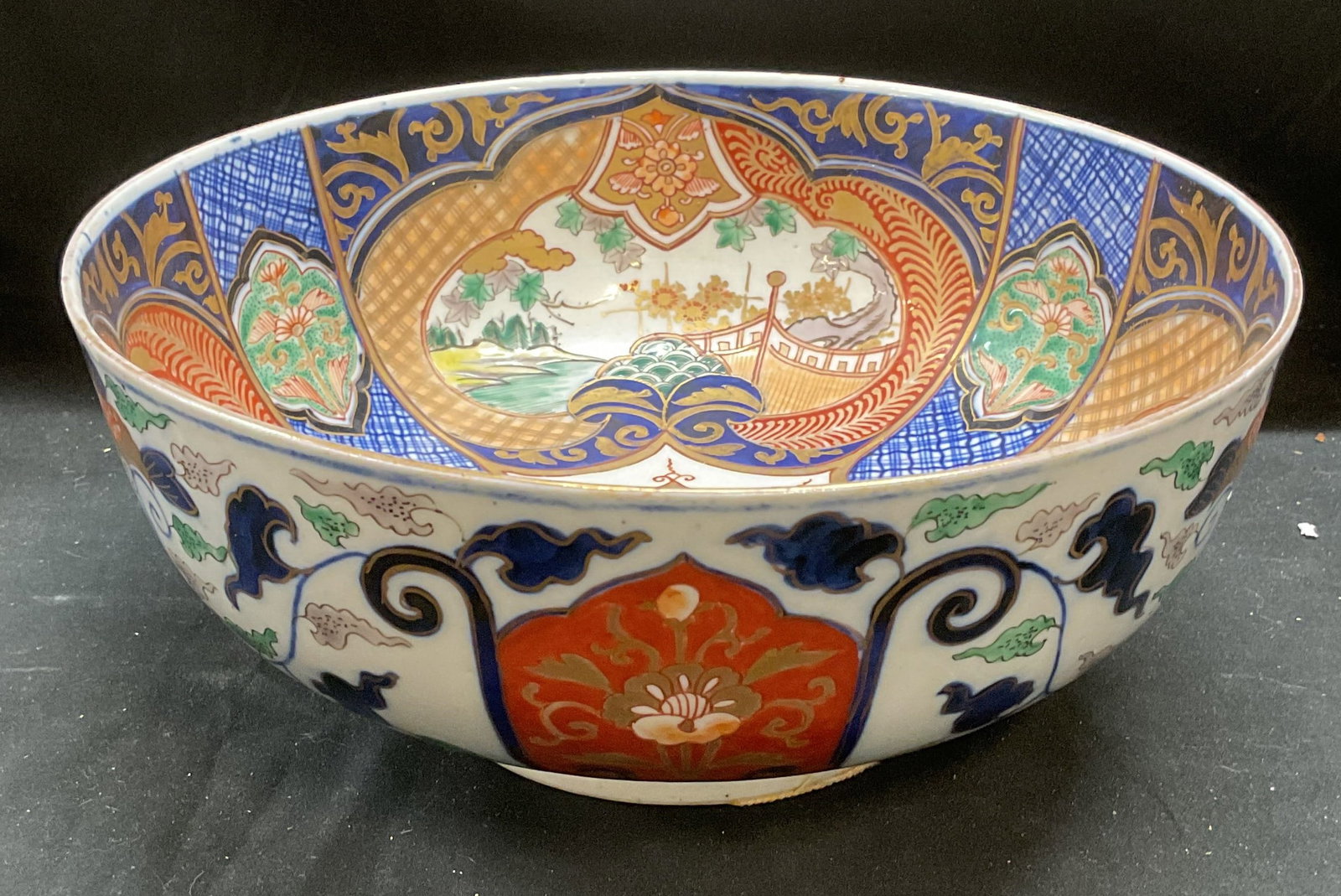 Vintage Hand Painted Porcelain Imari Bowl: Vintage hand painted Asian porcelain bowl. Appears to be Imari ware. Blue, red, and green with gilt decoration and traditional style motifs. Measures approx 9.75 x 4.25 inches. Some wear including scr