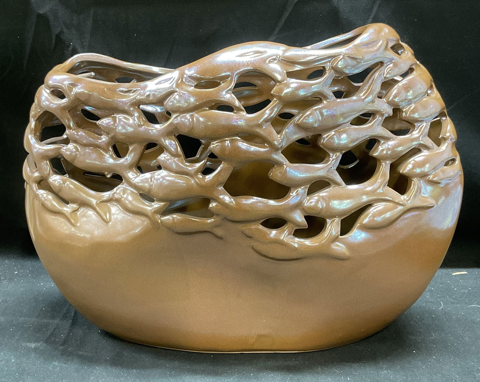Vintage Iridescent Art pottery Fish Vase: Vintage iridescent art pottery vase in brown with pierced detail and school of swimming fish motif. Measures approx 12 x 5 x 9.5 inches. Some wear consistent with exposure. Art pottery, art pottery va