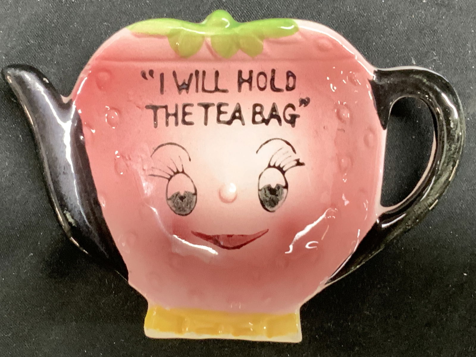 Vntg Anthropomorphic Ceramic Teabag Holder JAPAN: Vntg Anthropomorphic Ceramic Teabag Holder JAPAN Ceramic teabag holder that features a strawberry form teapot with a face & a handle. Teabag holder has black bold lettering that reads I WILL HOLD THE