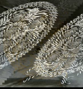Crystal Floral Serving Platter W Saw Toothed Rim: Serving platter appears to be crystal. Possibly glass. Piece has floral & leaf detail. Platter has saw toothed rim. Piece has floral relief detail. Platter measures approximately 14 inches diameter. P