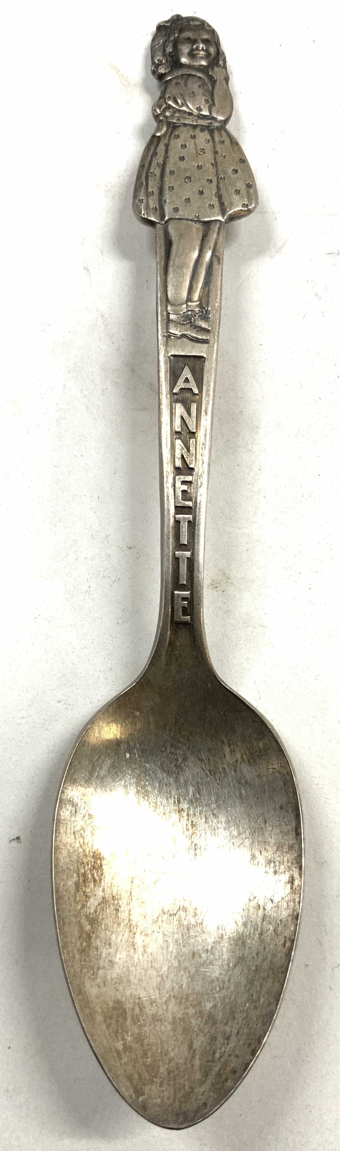 Carlton Silv Pl ANNETTE Dionne Quintuplets Spoon 1964: Backside is inscribed CARLTON SILVER PLATE. Front side reads ANNETTE. Spoon handle is in the form of Annette with relief detail. Spoon is silver plated. Piece is vintage circa 1964 (as reads on backsi