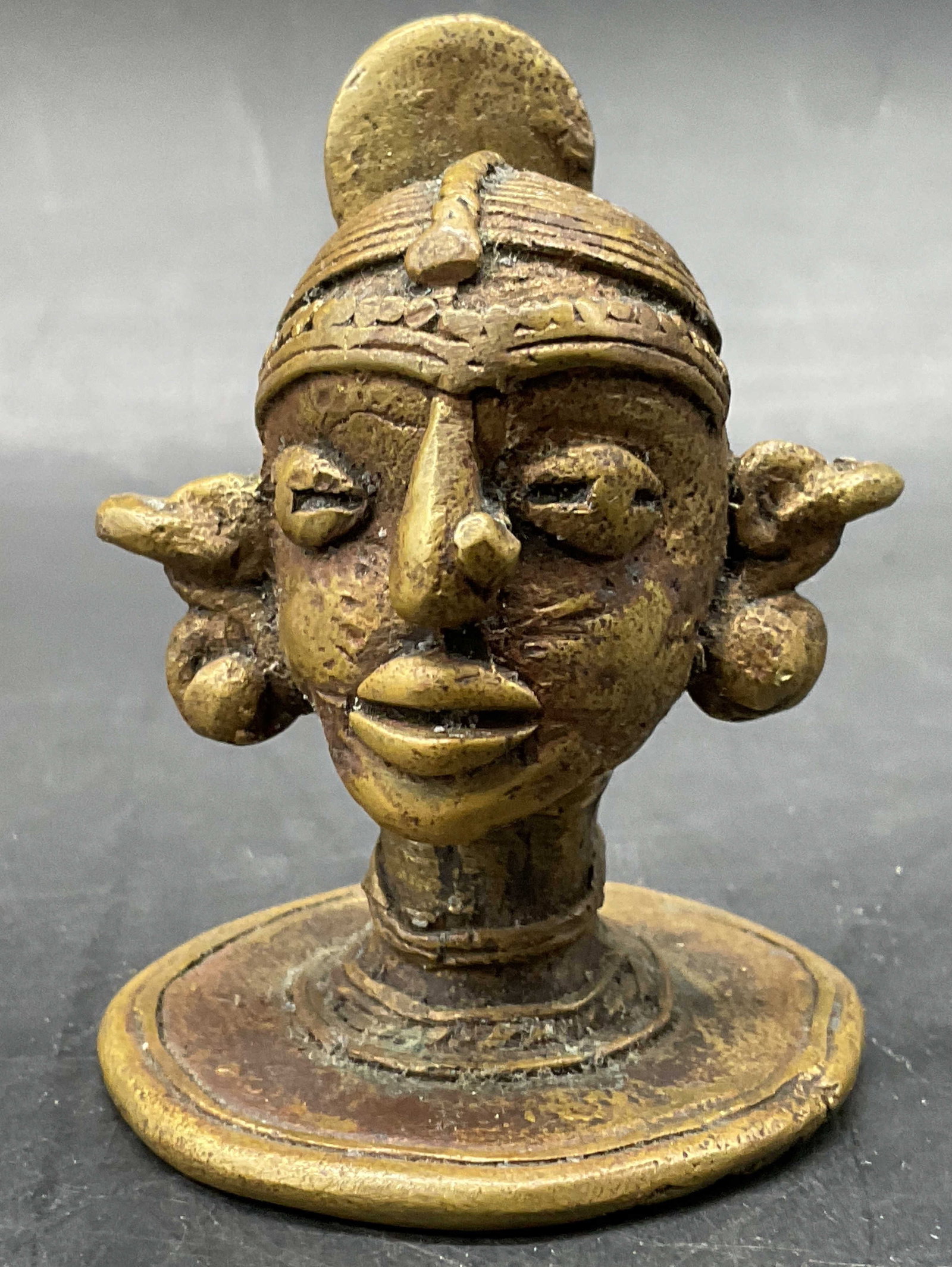 Vintage Brass Deity Head Figural: Vintage Brass Deity Head Figural. Appears to be brass, possibly a brass finished metal. Measures approx. 2.25H x 1.75W in. Discoloration and surface wear present. home decor, home accents, homewares, 