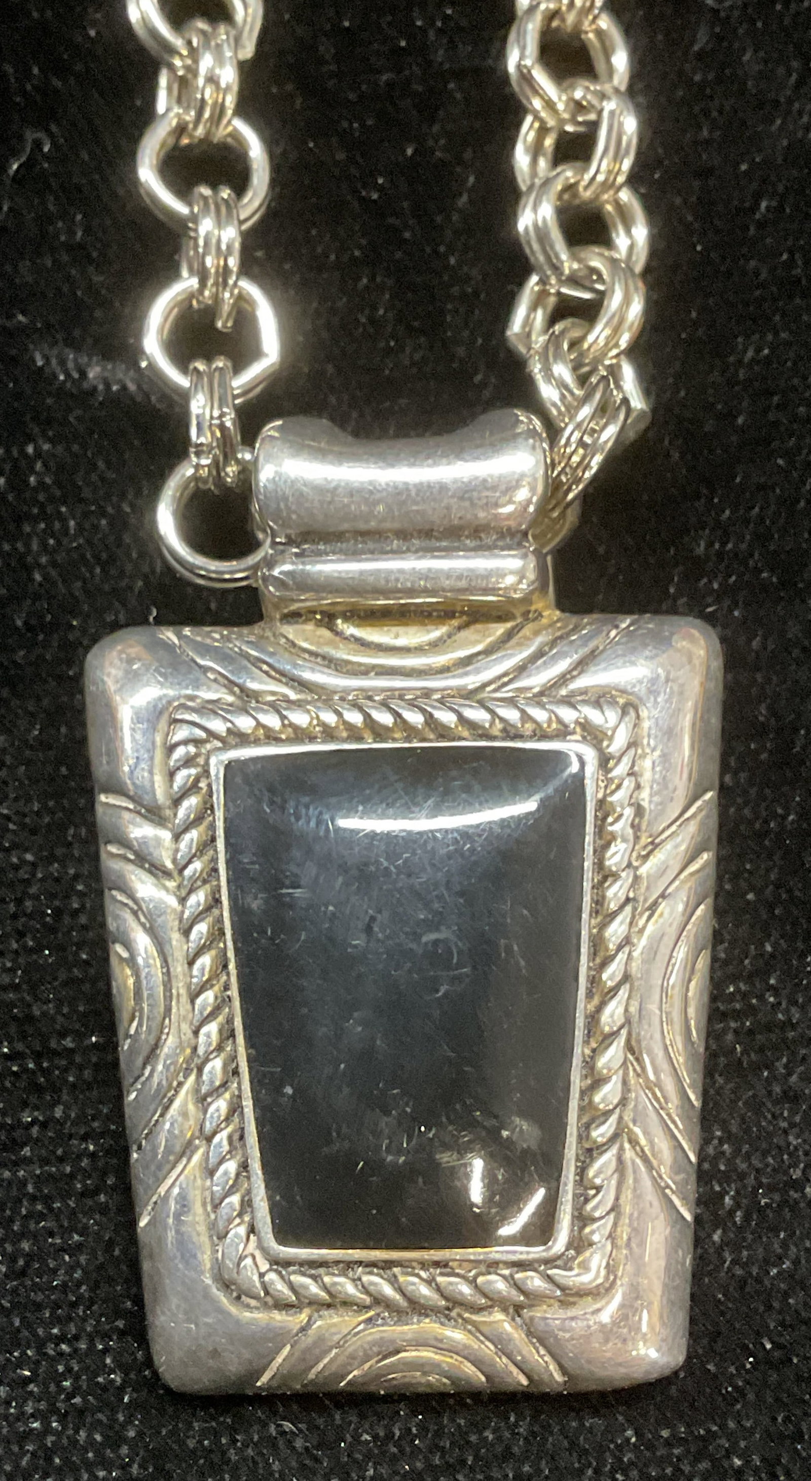 Signed Silver Tone Black Pendant Necklace: Silver tone chain necklace with silver tone and black enameled pendant. Signed on pendant. Drop length approx 11 inches. Pendant approx 1.5 x 1 inches. Some wear including scratching. Jewelry, estate 