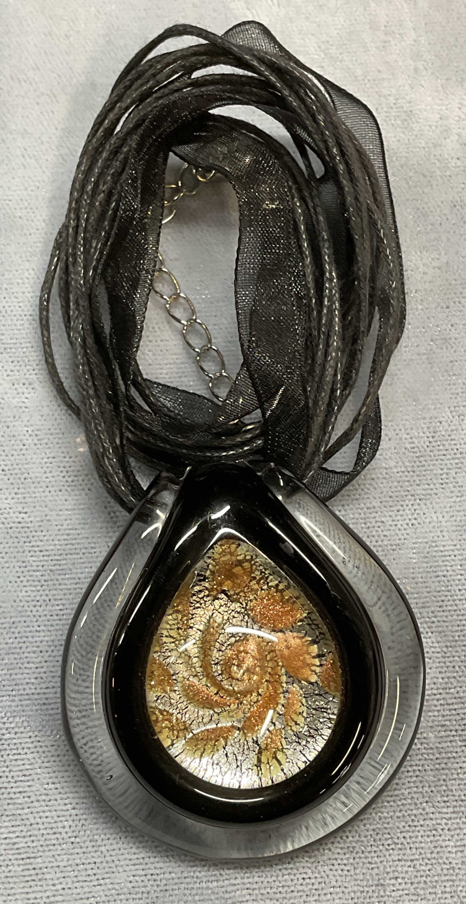Black Gold Tone Art Glass Pendant Necklace: Black multi strand necklace with black, silver and gold tone art glass pendant. Drop length approx 10 inches. Some wear including scratching observed. Jewelry, estate jewelry, costume jewelry, cocktai
