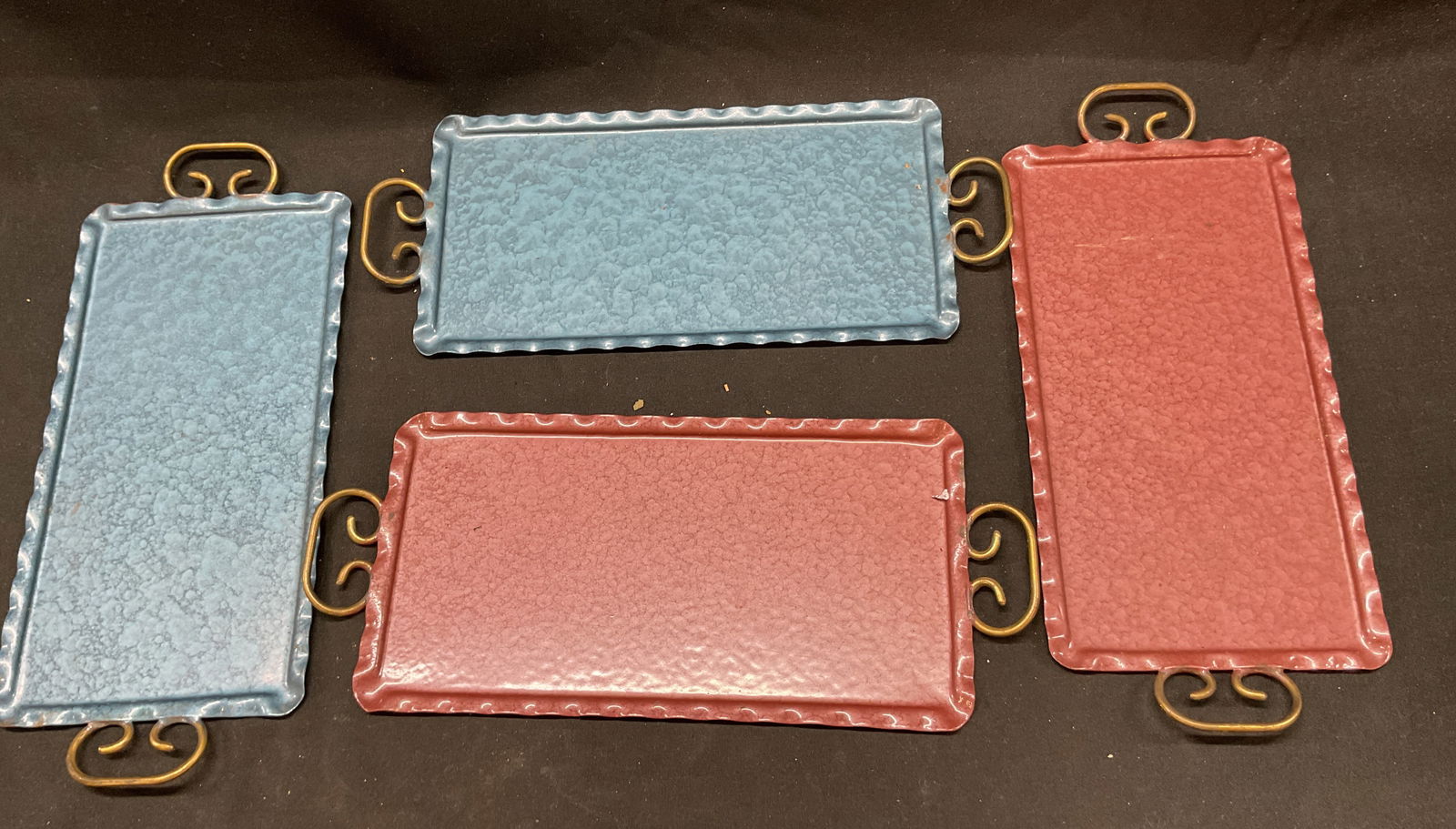 Set 4 Steel Metal Blue Pink Scroll Handle Trays: Set 4 steel metal blue pink scroll hand trays. Flat metal trays with scalloped edges and crook handle designs. 9.5 x 4 inches including handle. Some surface wear consistent with exposure, loss in colo