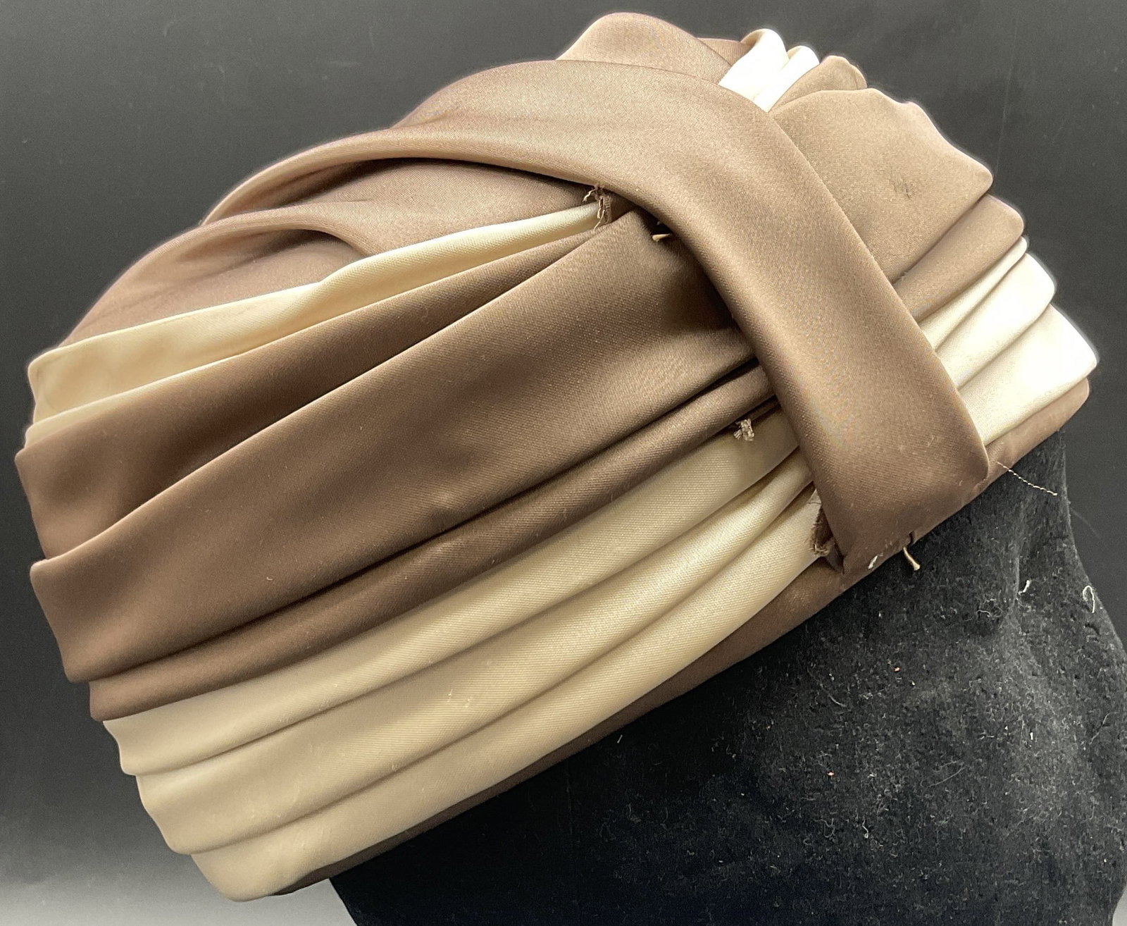 DANA ORIGINAL Vintage Folded Fabric Hat, Usa: DANA ORIGINAL Vintage Folded Fabric Hat. Tag to interior reads DANA ORIGINAL. Other tag reads UNION MADE, USA. Crafted from a satin style material. Brown and cream hues. Measures approx. 7L x 7W in. S