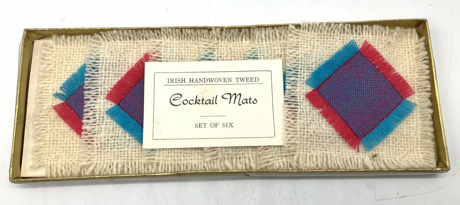 Lot 6+ Irish Handwoven Tweed Cocktail Mats NIP: Lot 6+ Irish Handwoven Tweed Cocktail Mats NIP Lot includes set of 6 Irish handwoven cocktail mats. Mats feature shades of blue, pink & cream. Appears to be new in plastic. Surface wear consistent to