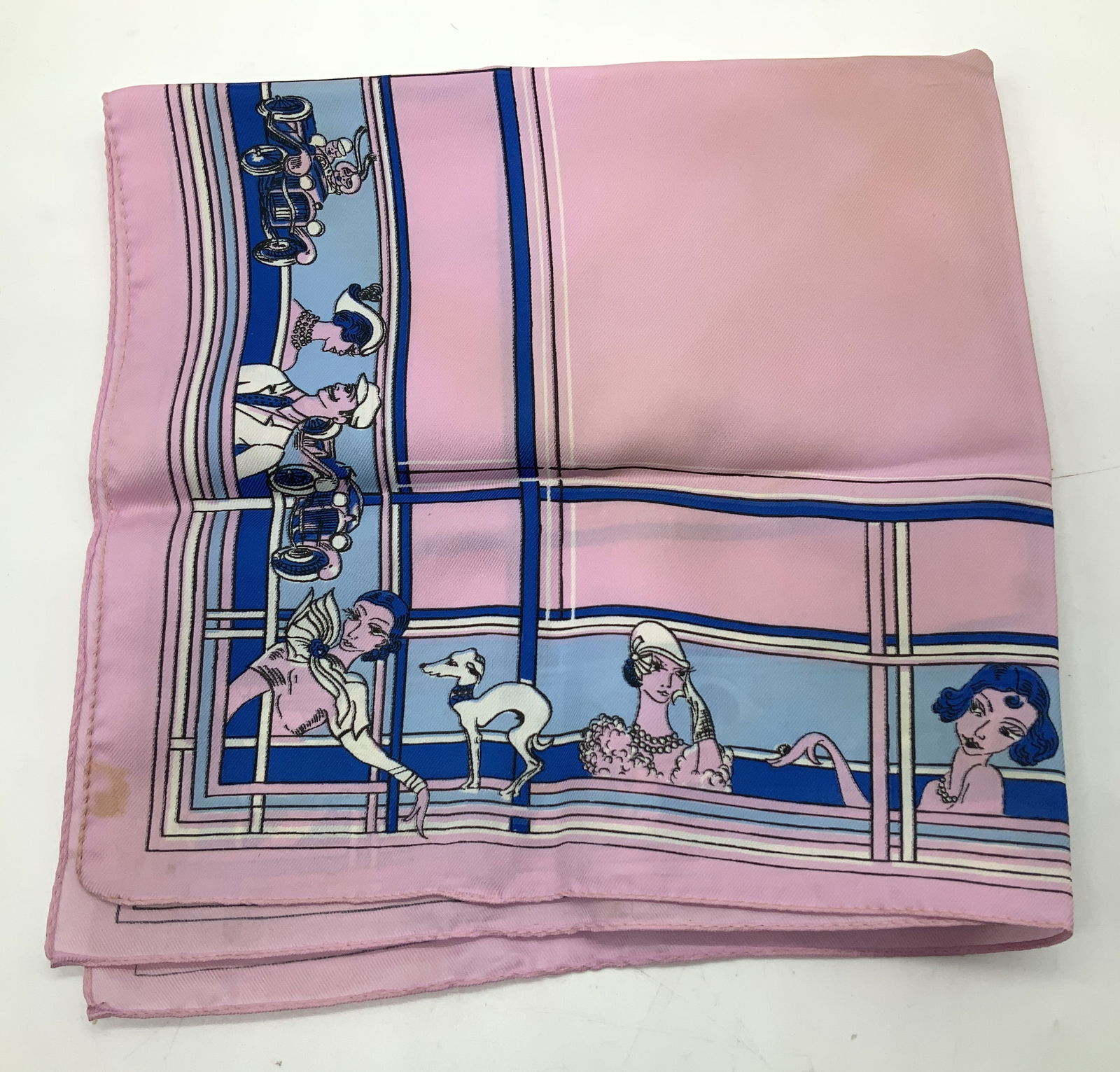 Vintage Classic Car Lady Silk Print Scarf: Scarf appears to be possible silk. Scarf features pink & blue colors with classic cars & elegantly dressed woman on the borders. Surface wear consistent to age, use & exposure. Measurements: length 20
