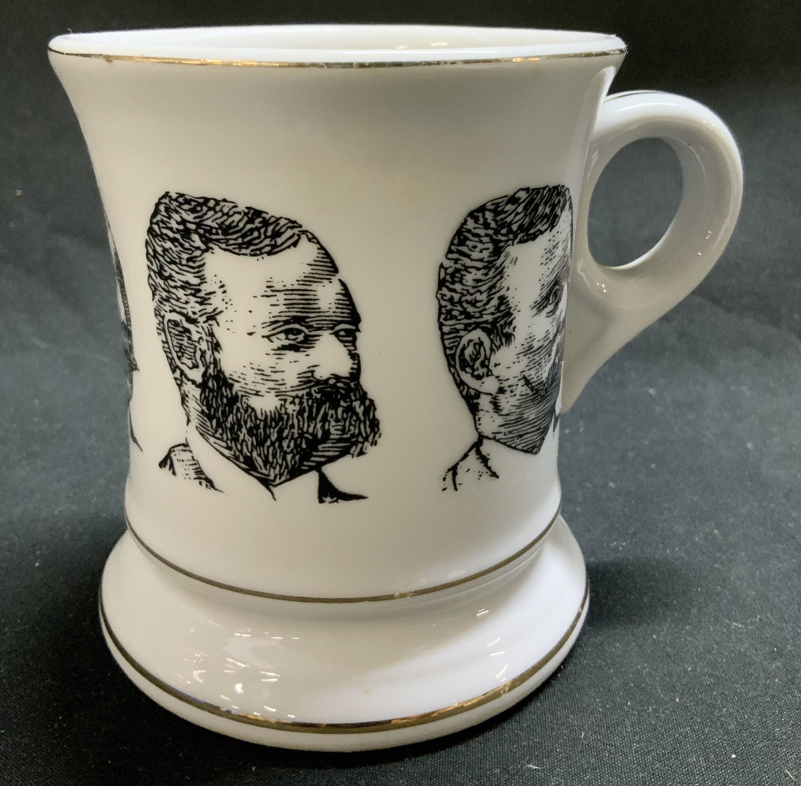 Vntg Portrait Gentleman Porc Mustache Stein: Vntg Portrait Gentleman Porc Mustache Stein Porcelain stein featuring portraits of 5 gentlemen. Stein has a mustache guard that sits across the rim. Mug has gold accents. Surface wear consistent to ag