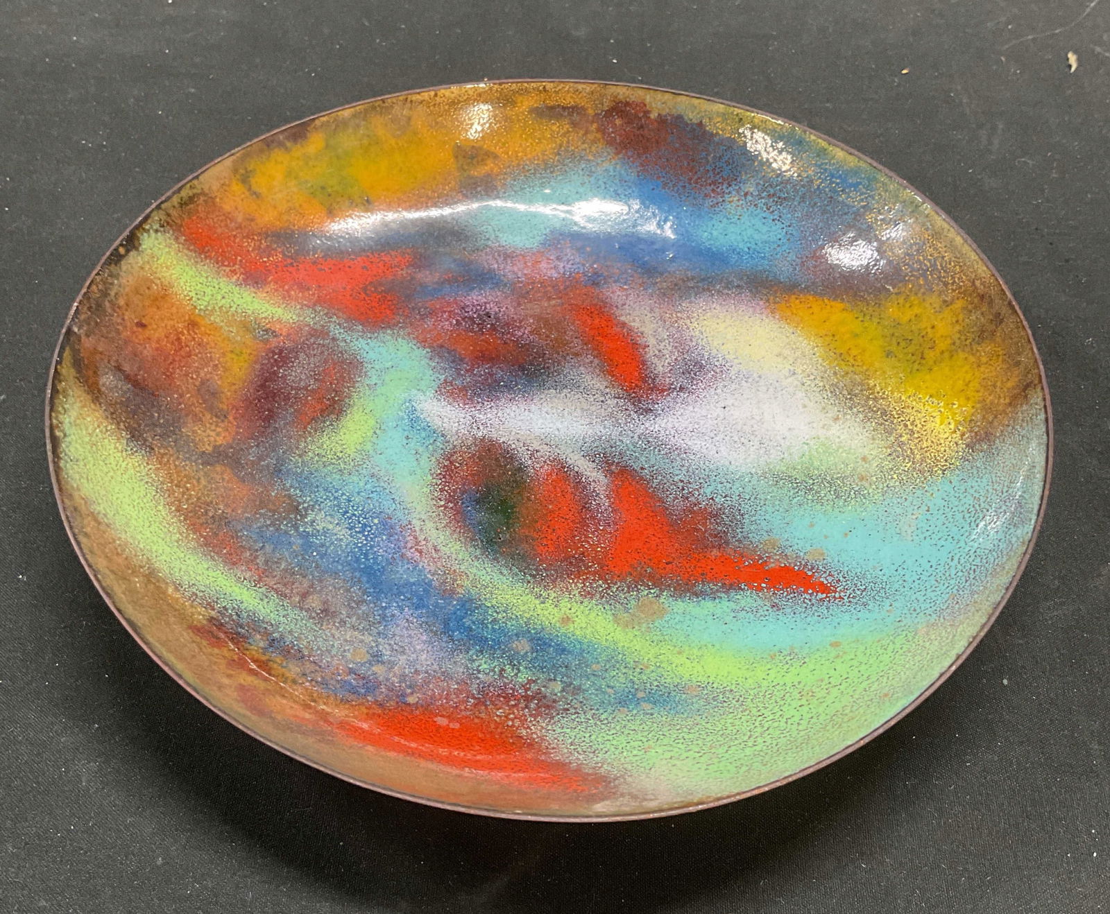 Vtg Hand Painted Multicolor Enamel Copper Bowl: Vintage enameled copper bowl. Hand painted multicolor palette of bright red, blue, yellow, and green. Abstract pattern. Measures approx 7.5 x 1.25 inches. Some scratching observed. Decorative object,