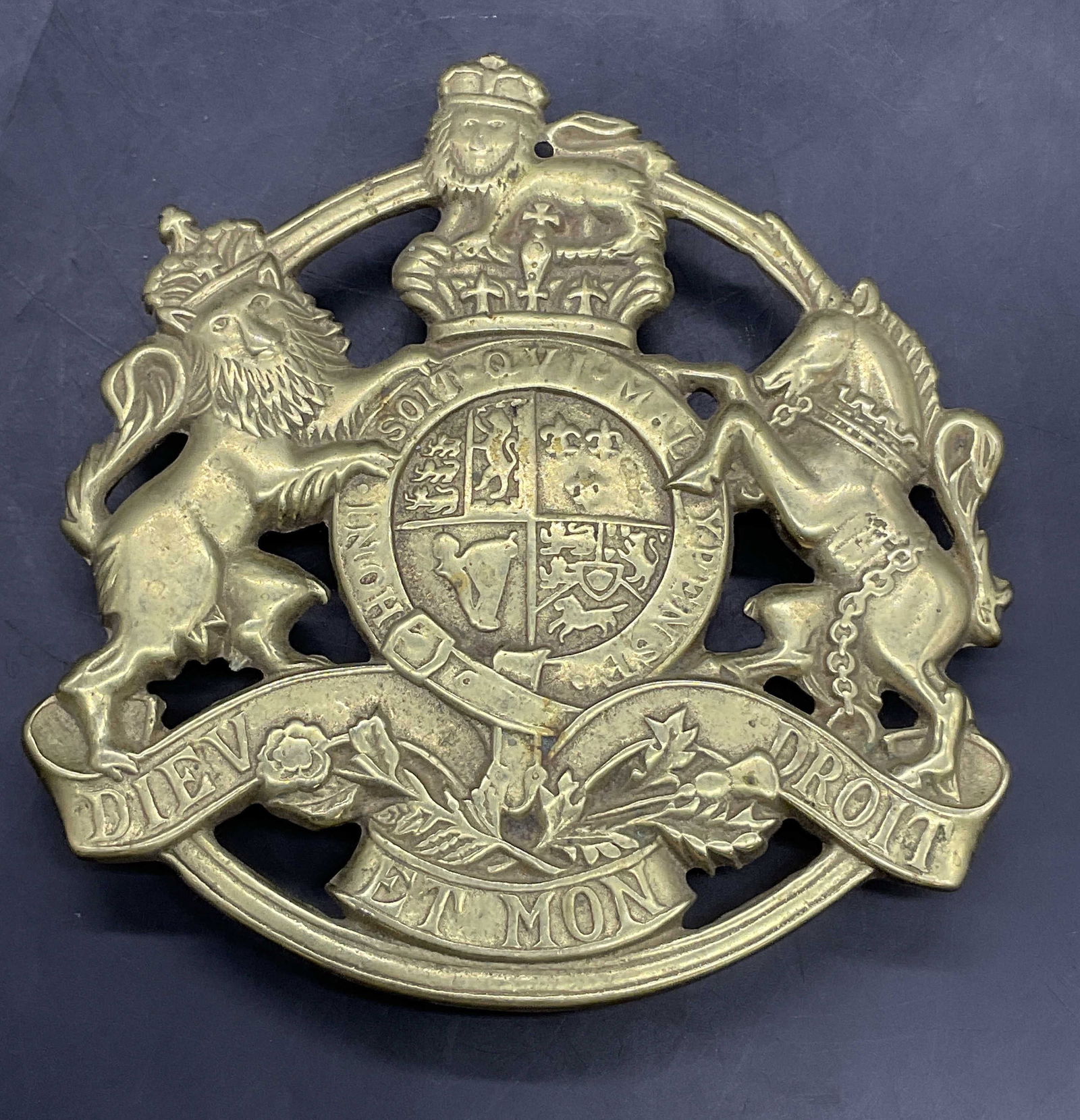 1953 KINGS ARMS TRIVET Brass Crest Motif Trivet: 1953 KINGS ARMS TRIVET Brass Crest Motif Trivet. The crest features mythological creatures. Underside reads KINGS ARMS TRIVET, COPYRIGHT 1953. Other verbiage illegible. Obverse verbiage is worn, can r