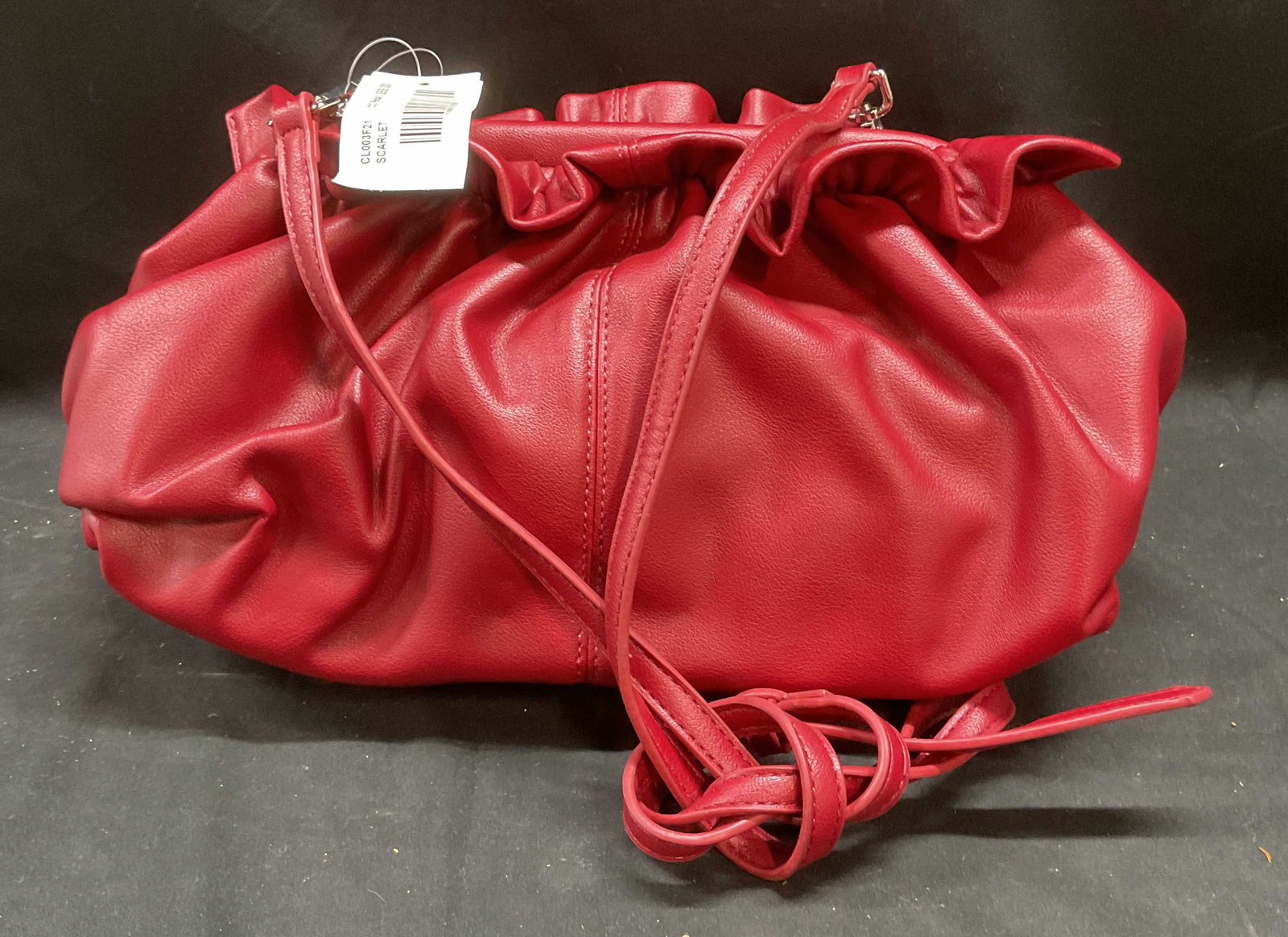 Red Faux Leather Ruffle Handbag NWT: Red faux leather handbag with ruffle trim. New with tag. Interior pocket. Measures approx 12 x 4 x 6 inches. Some wear consistent with exposure. Handbag, faux leather handbag, red handbag, ruffle hand