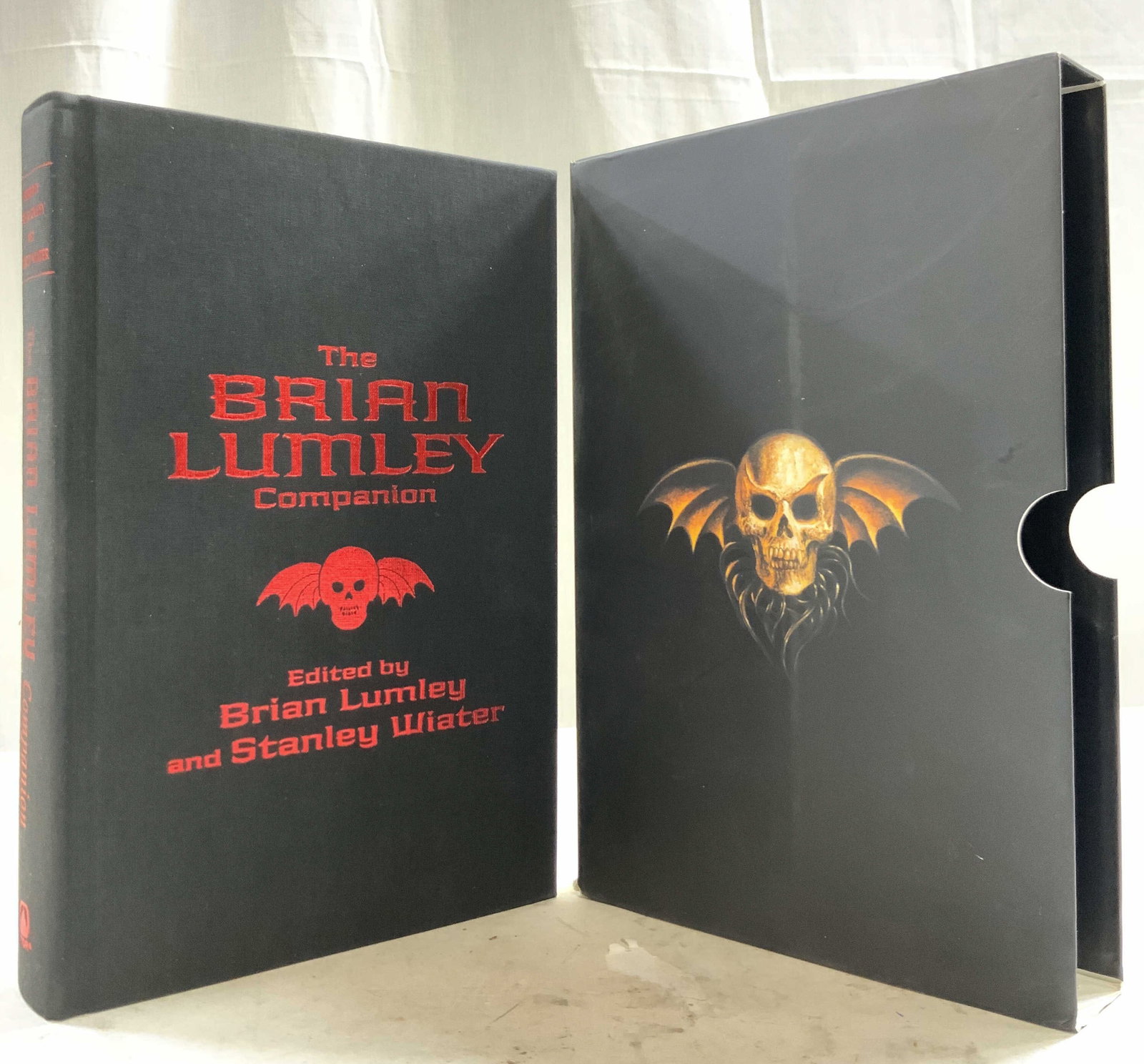 THE BRIAN LUMLEY COMPANION LUMLEY 2002 1st Ed: Cover reads THE BRIAN LUMLEY COMPANION. EDITED BY BRIAN LUMLEY AND STANLEY WIATER. First Edition Published 2002 by ShadoWind Inc. Book is hardcover, black toned with red lettering and winged skull. Tw