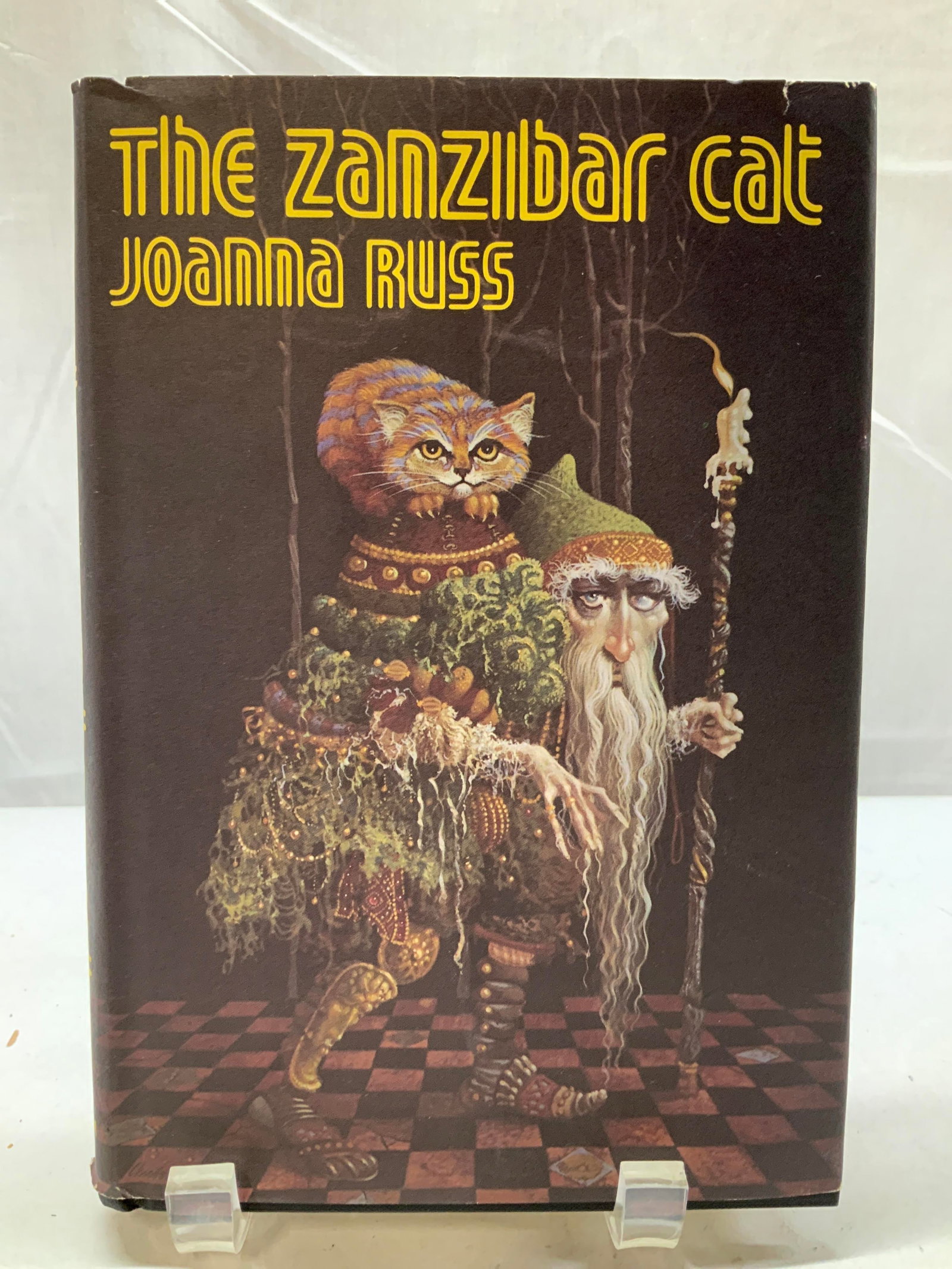 1983 The Zanzibar Cat First Ed. Illustr Book RUSS: 1983 The Zanzibar Cat First Ed. Illustr Book RUSS The Zanzibar Cat by Joanna Russ. Foreword by Marge Piercy & drawings by Dennis Neal Smith. Front cover features illustrations of an orange cat & an ol