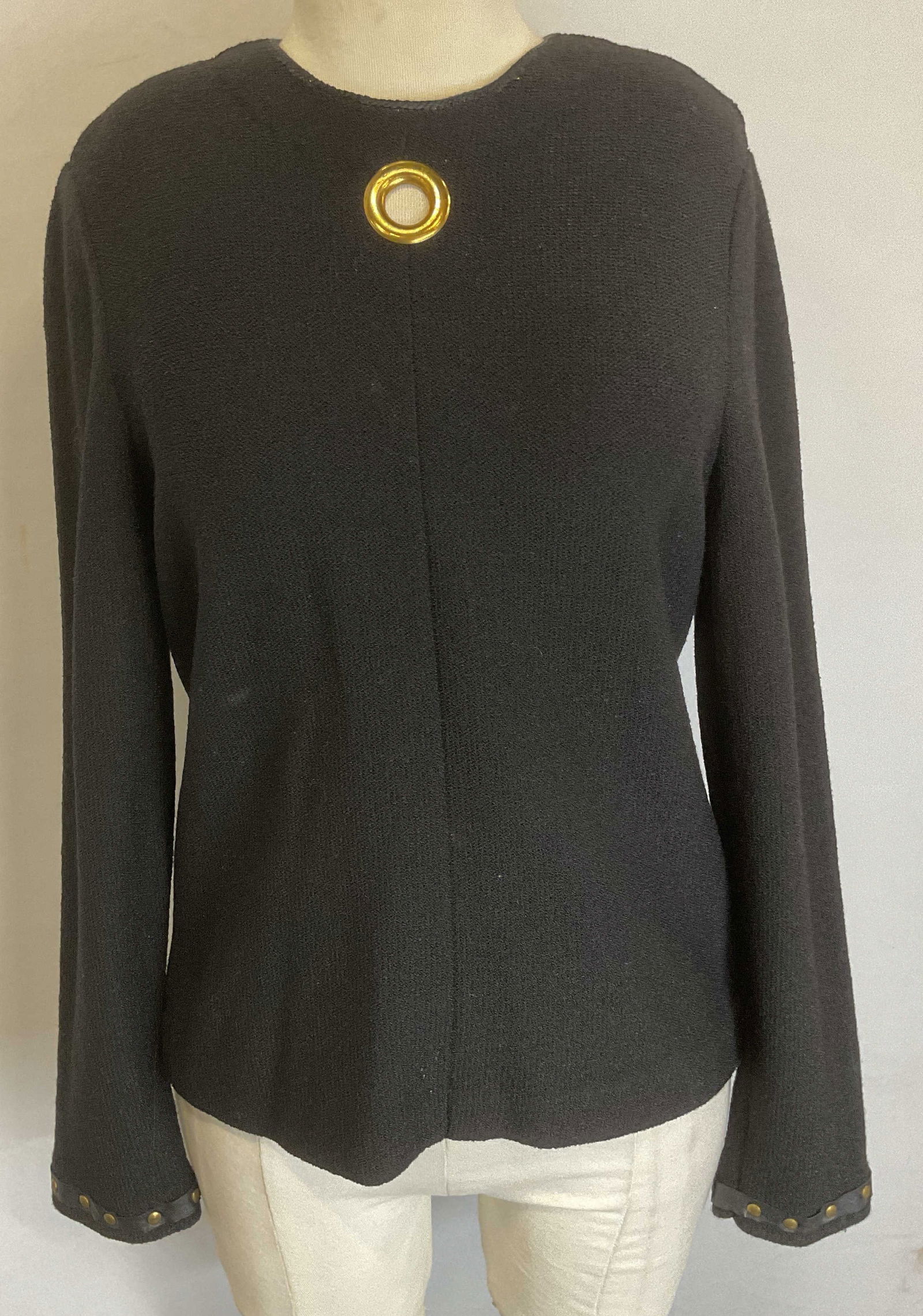 Vtg Steve Fabrikant Black Studded Keyhole Sweater: Vintage Steve Fabrikant black knit long sleeve sweater with brass studded sleeve detail and front chest grommet keyhole back zipper. Measures approx 17.5 inches across chest. Wool blend. Some wear to