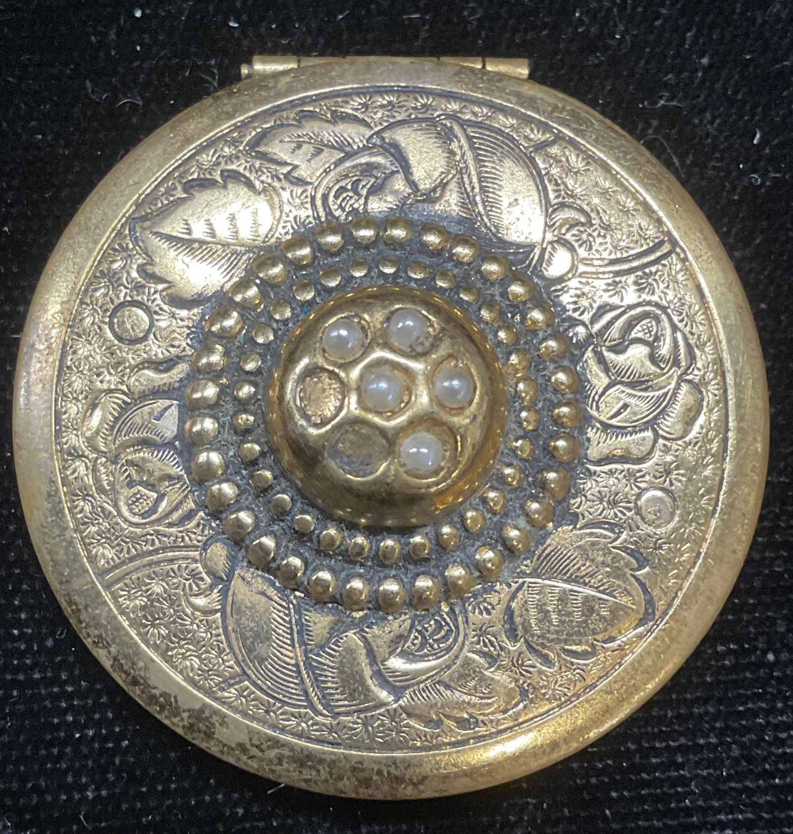 Vintage Gold Tone Floral Faux Pearl Locket: Vintage gold tone locket with faux pearl decoration and raised floral scroll motif. Measures approx 1.5 inches wide. Some loss to pearls. Some wear including scratching. Jewelry, estate jewelry, costu