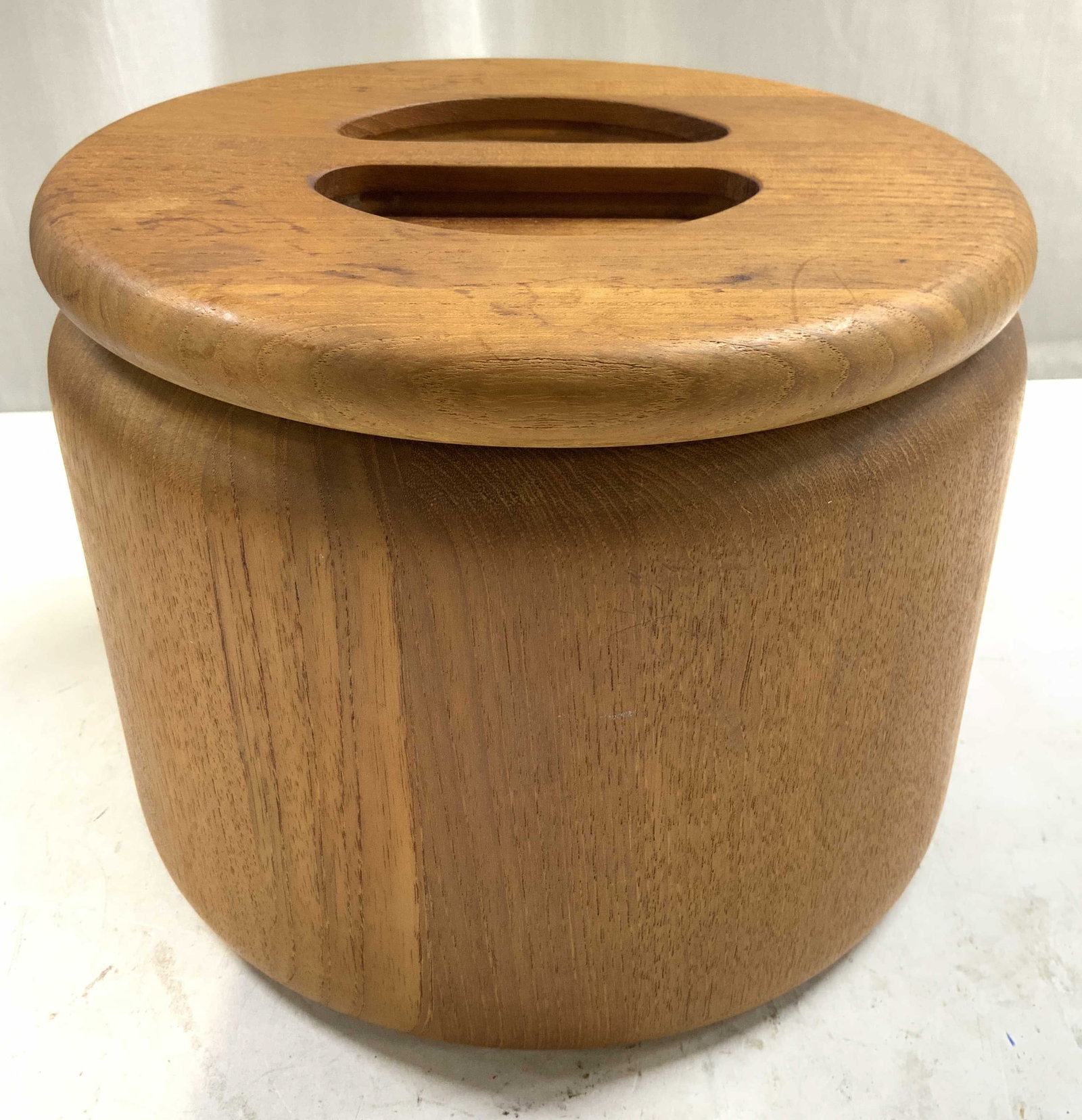 THE CELLAR Teakwood Ice Bucket W Lid: Underside is inscribed THE CELLAR. Tag reads Made in Malaysia Expressively for R H Macy & Co Inc. Ice bucket is tan toned and wooden. Piece includes lid with handle. Measures approximately 7 inches ta