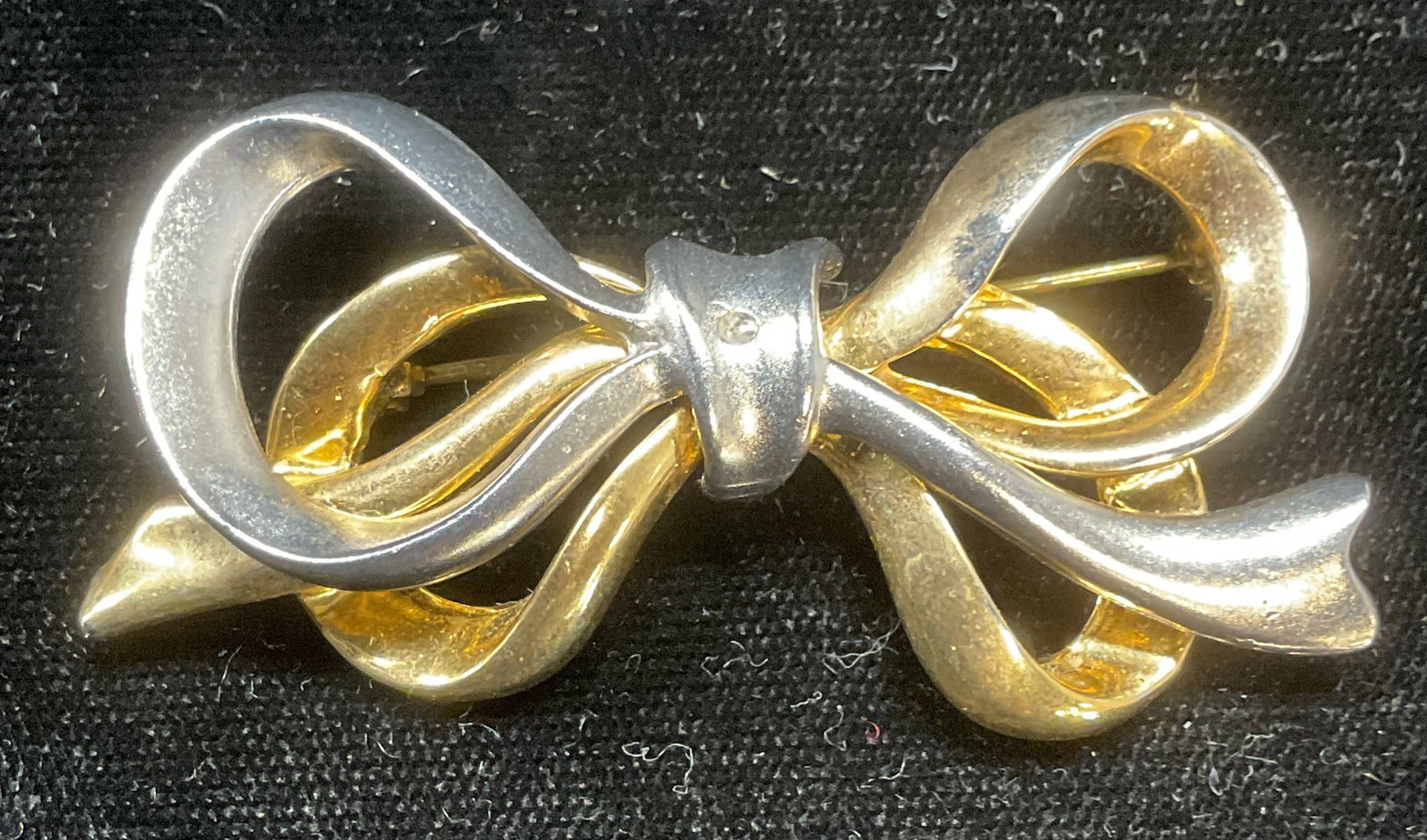 Vintage Silver & Gold Tone Bow Brooch: Vintage silver and gold tone bow motif brooch. Measures approx 1 x 2.25 inches. Some scratching observed. Jewelry, estate jewelry, costume jewelry, fashion jewelry, accessories, fashion accessories, w
