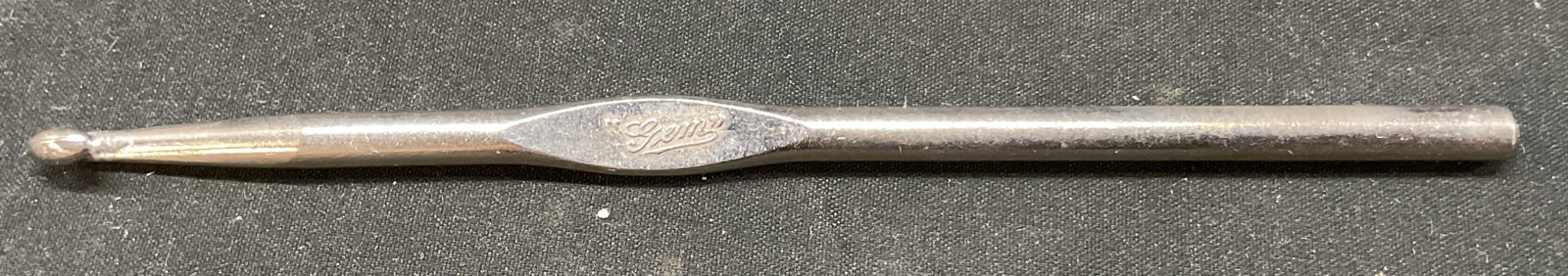 Vtg GEM Stainless Steel Crochet Hook USA: Vintage GEM stainless steel crochet hook. Made in USA. 6 inches long. Marked I, hook appears to be used for 5 or 6 mm yarn material. Some surface wear including discoloration present. GEM, crochet hoo