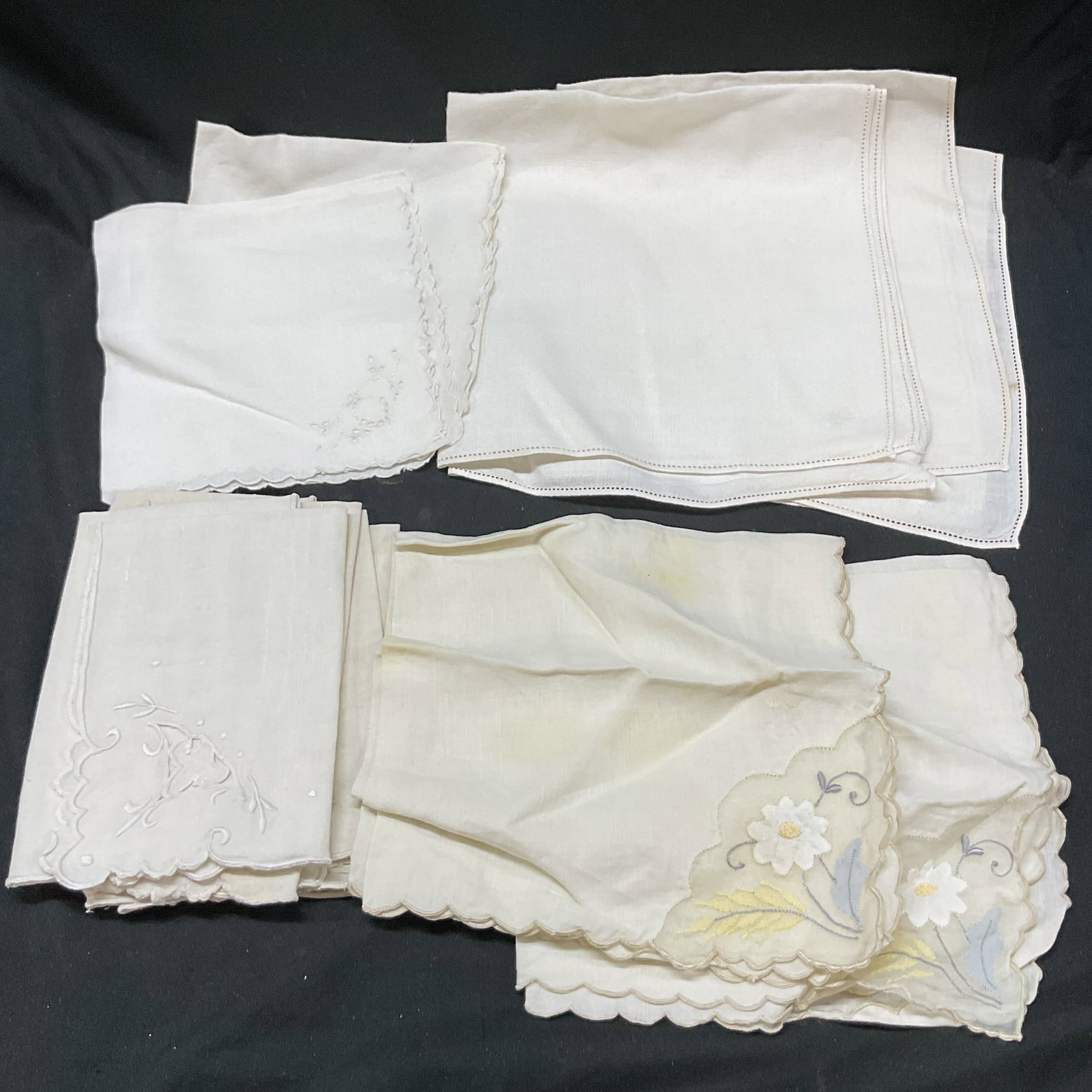 Lot 11 Vtg Table Linen Cream Napkins Handkerchiefs: Lot 11 vintage table linen cream napkins handkerchiefs. Embroidered, cut out, scalloped edge patterns. Largest napkins measures 16 inches. Some surface wear including light discoloration, tearing and