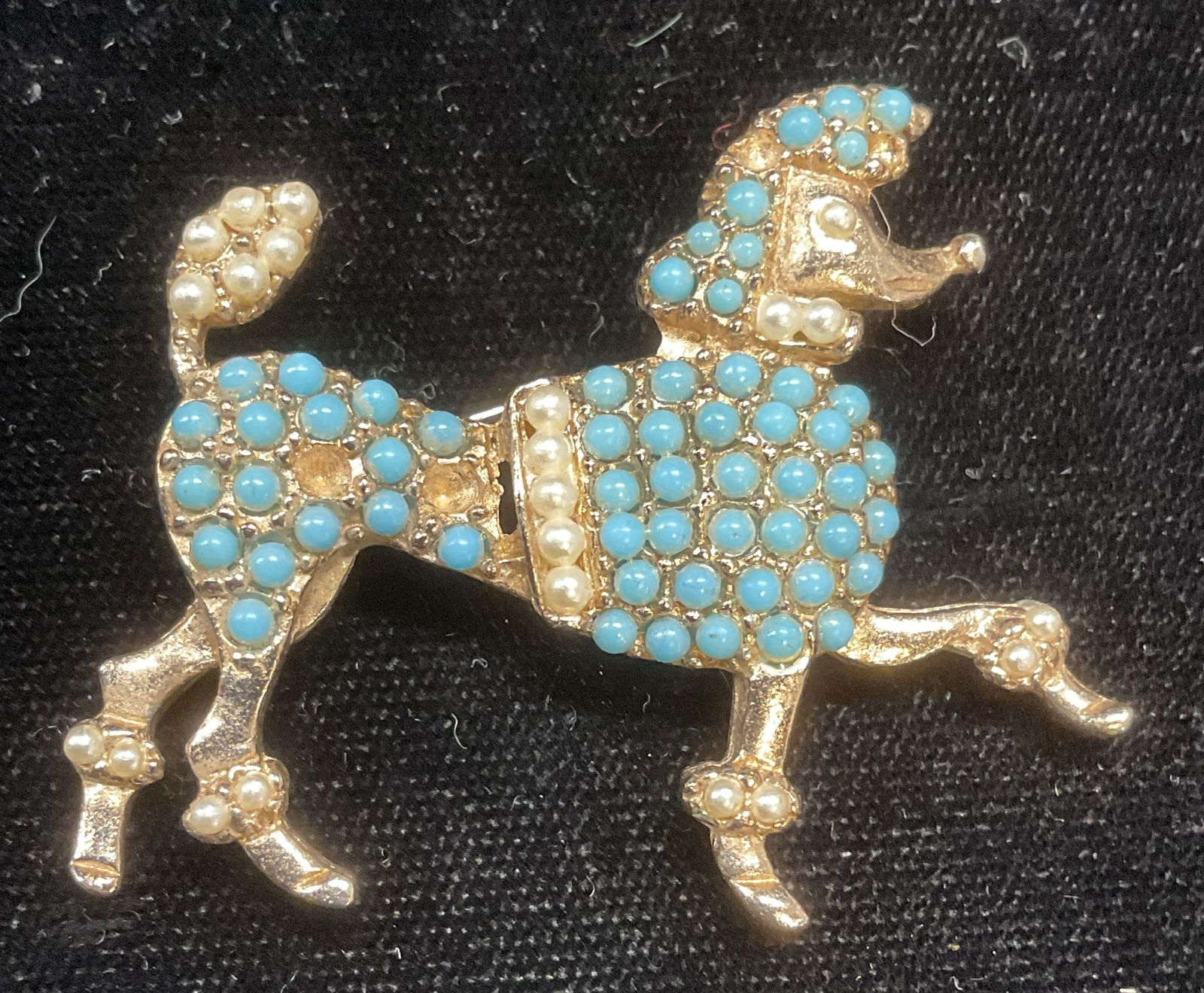 Vintage Gold Tone Lucite Turquoise Poodle Brooch: Vintage gold tone poodle dog motif brooch with lucite turquoise cabochons and faux pearls. Measures approx 1.5 x 1.75 inches. Some cabochons need replacement. Some wear including scratching observed.