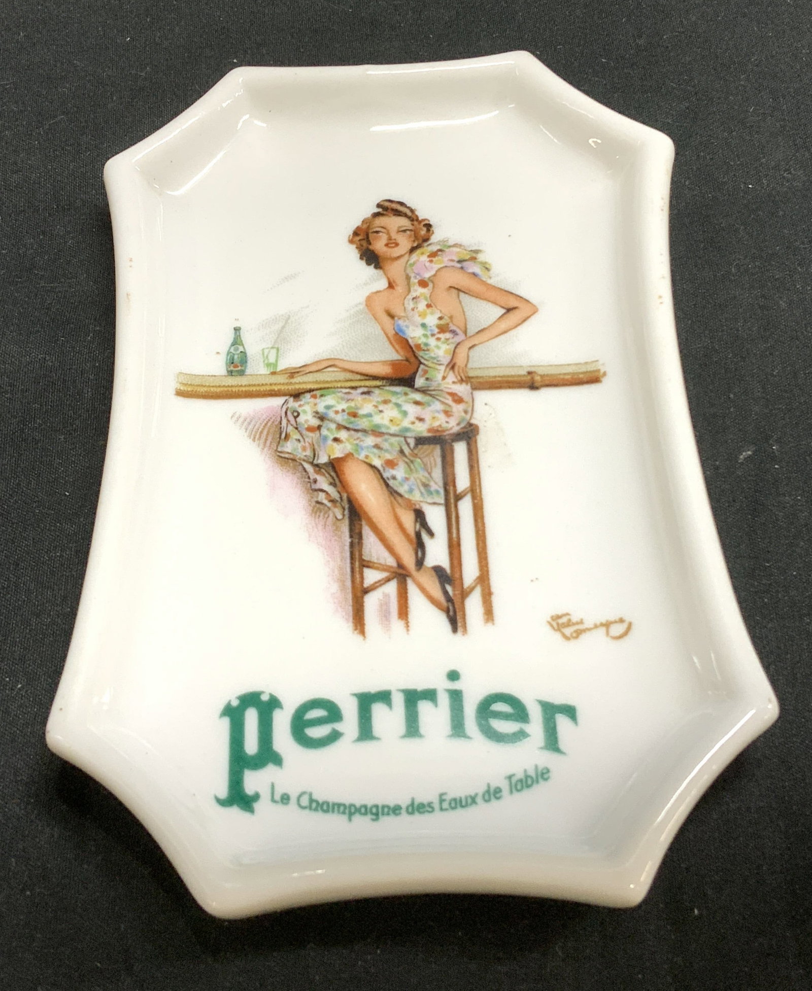 Perrier Souvenir Porc Trinket Dish LIMOGES FRANCE: Perrier Souvenir Porc Trinket Dish LIMOGES FRANCE Vntg Perrier souvenir/advertising dish, featuring an illustration of a woman the slogan PERRIER LE CHAMPAGNE DES EAUX DE TABLE. Signed & marked on und