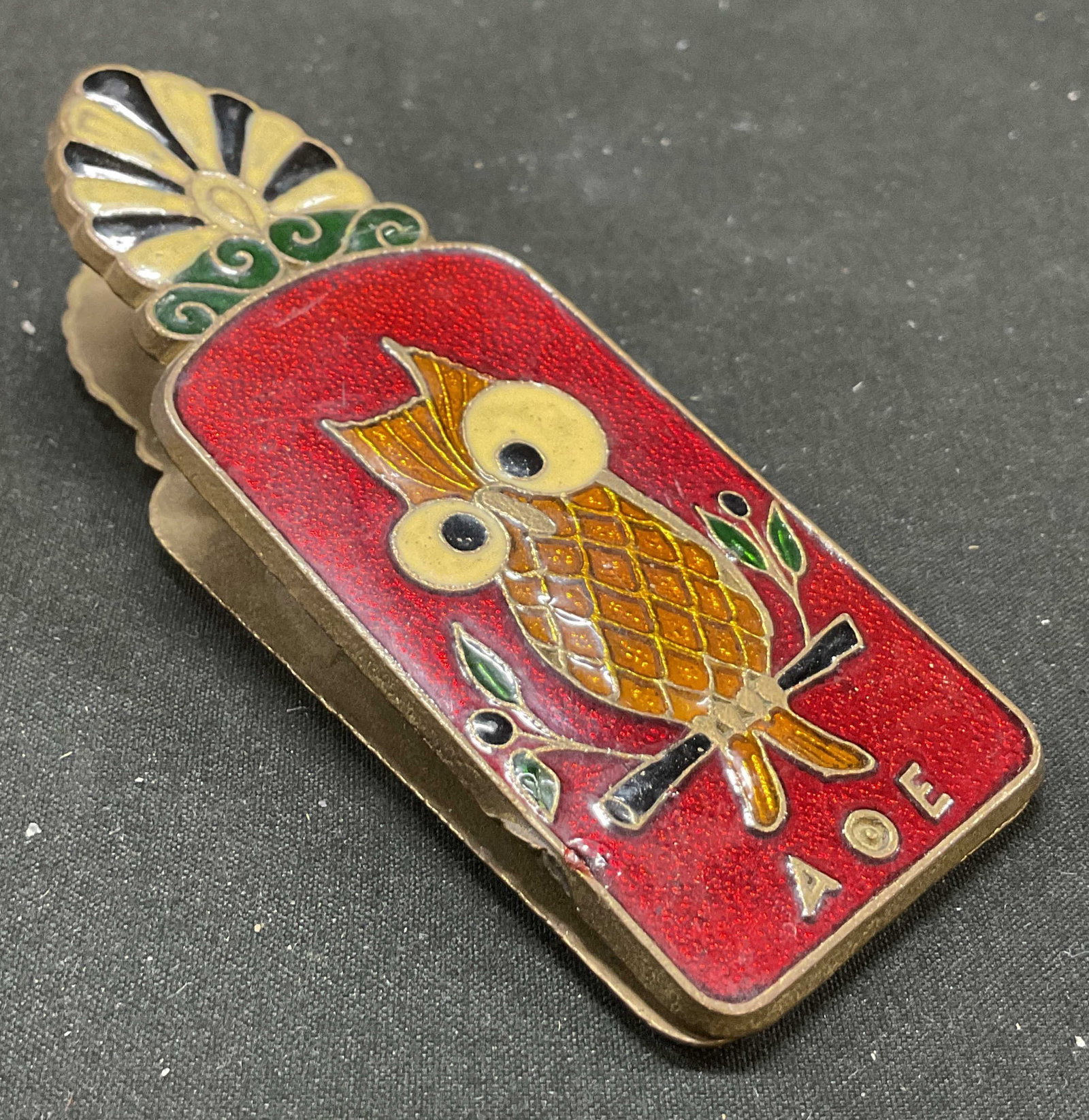 Vtg Brass AOE Owl of Athena Enamel Clip Holder: Vintage brass AOE Owl of Athena enamel clip holder. Owl of Athena on red background and scene with pillar on green background design. Alpha theta epsilon knowledge colorful metal clip holder. Front an