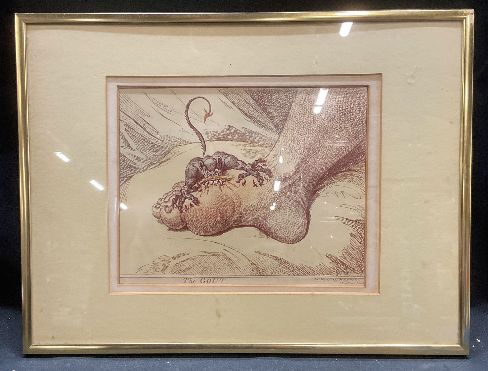 Framed After Gillray The Gout Fine Art Print: Framed and matted fine art print. After James Gillray. The gout. Inflamed foot with demon biting and clawing. Gold tone metal frame. Frame measures approx 12.5 x 16.5 inches. Some wear consistent with