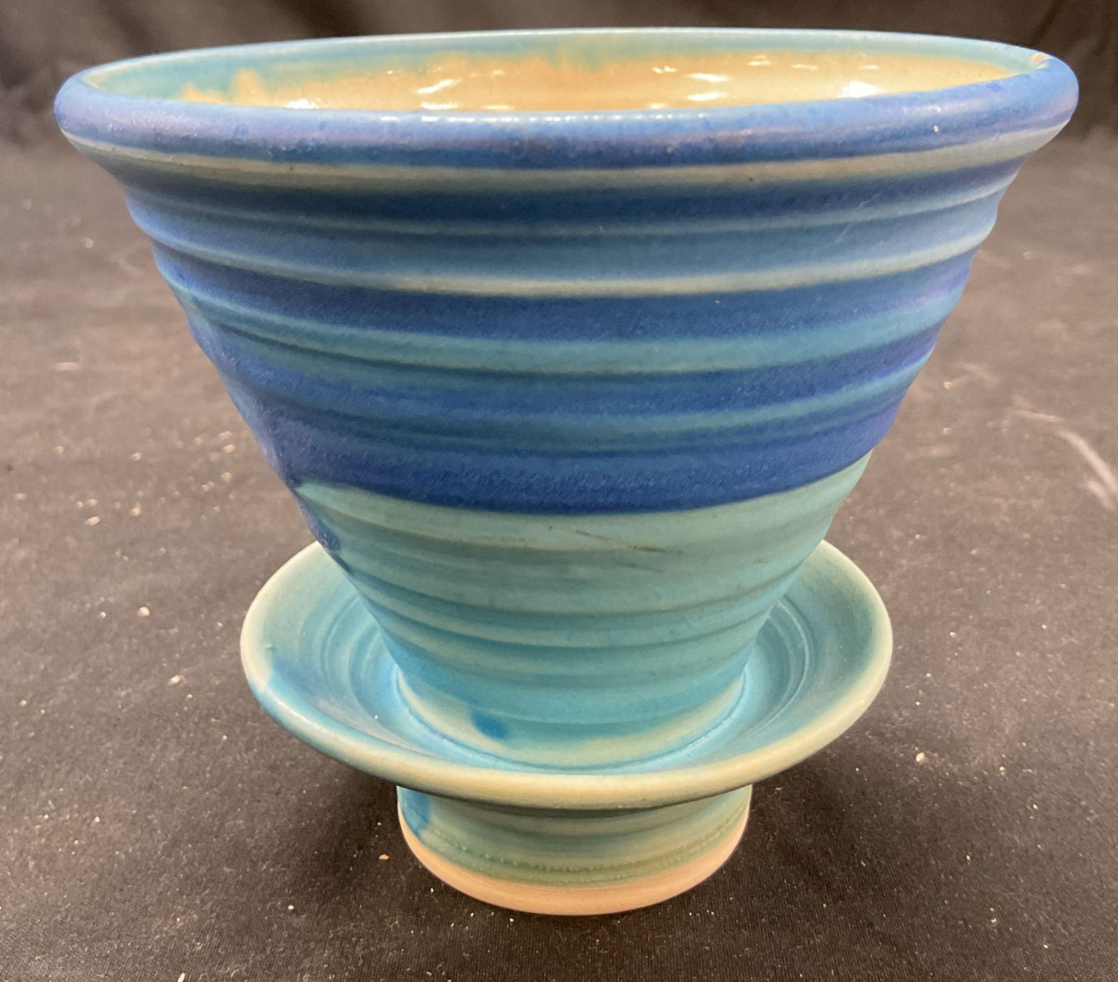 Vtg Blue Ceramic Pour Over Coffee Dripper: Vintage blue ceramic pour over coffee dripper. Colorful striped design in shades of blue and cream. Sits on a base or stand. 4 x 4.75 inches. Some surface wear consistent with exposure. Pour over coff