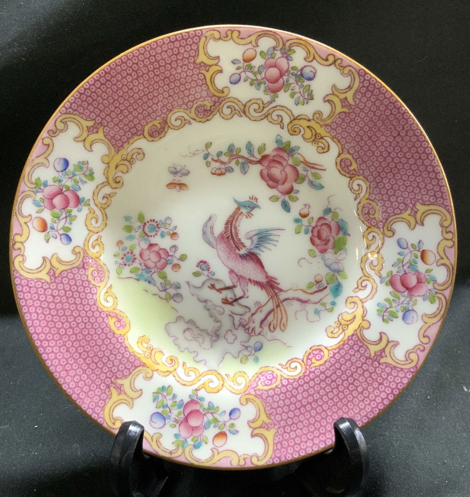 Vntg Mintons Pink Cockatrice Porc Plate ENGLAND: Plate has a distinctive pink cockatrice pattern. Pattern features of a mythological bird alongside colorful floral motifs. Signed & marked on underside. Reads, MINTONS ENGLAND, W.H.PLUMMER & CO. Surfa