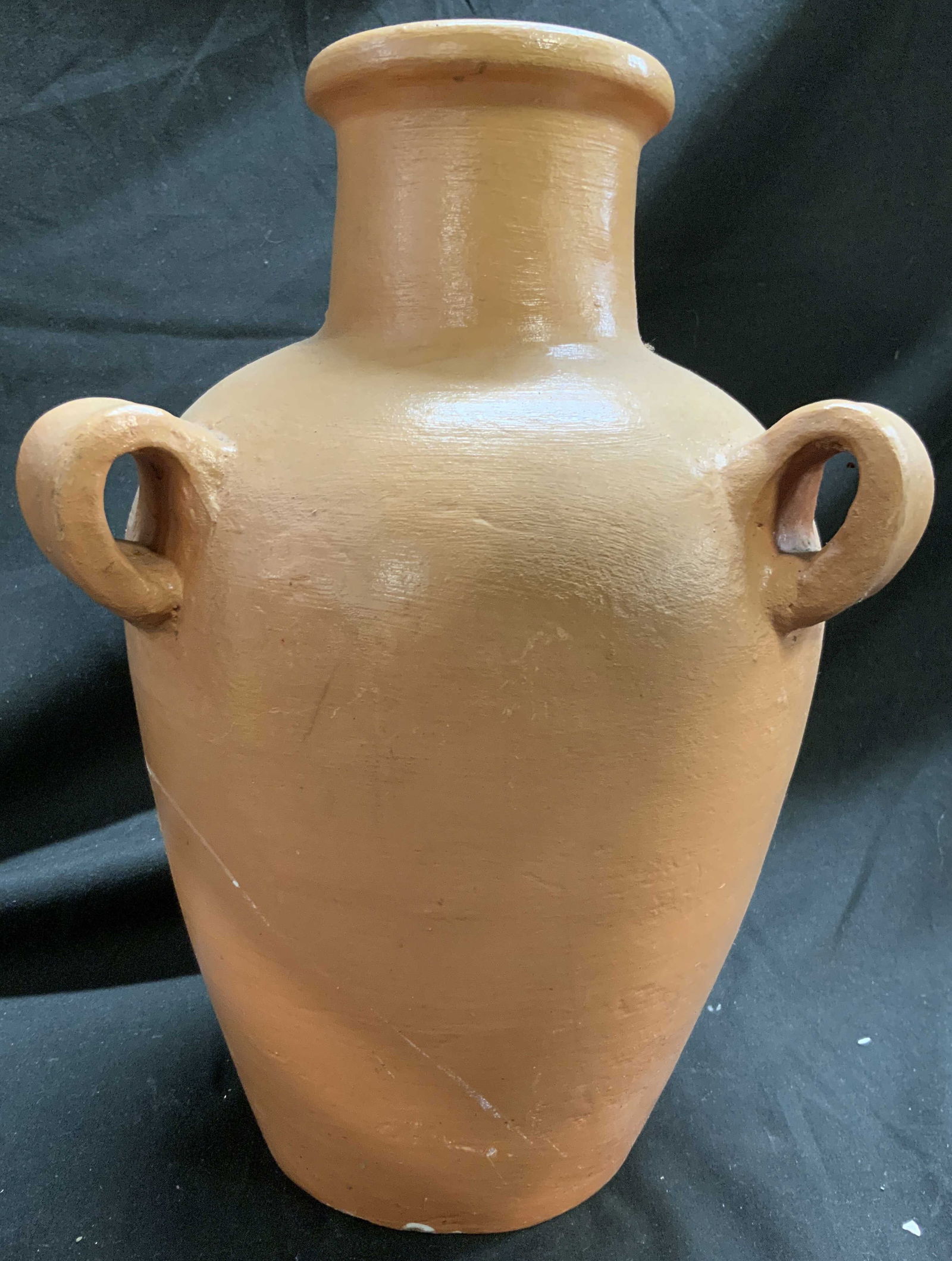 Vintage Terracotta Amphora Vase W Handles: Amphora appears to be terracotta possibly ceramic. Vessel is light orange toned. Vase has 3 loop form handles. Outer rim has lip. Vase appears to be vintage. Measures approximately 11.5 inches tall 8