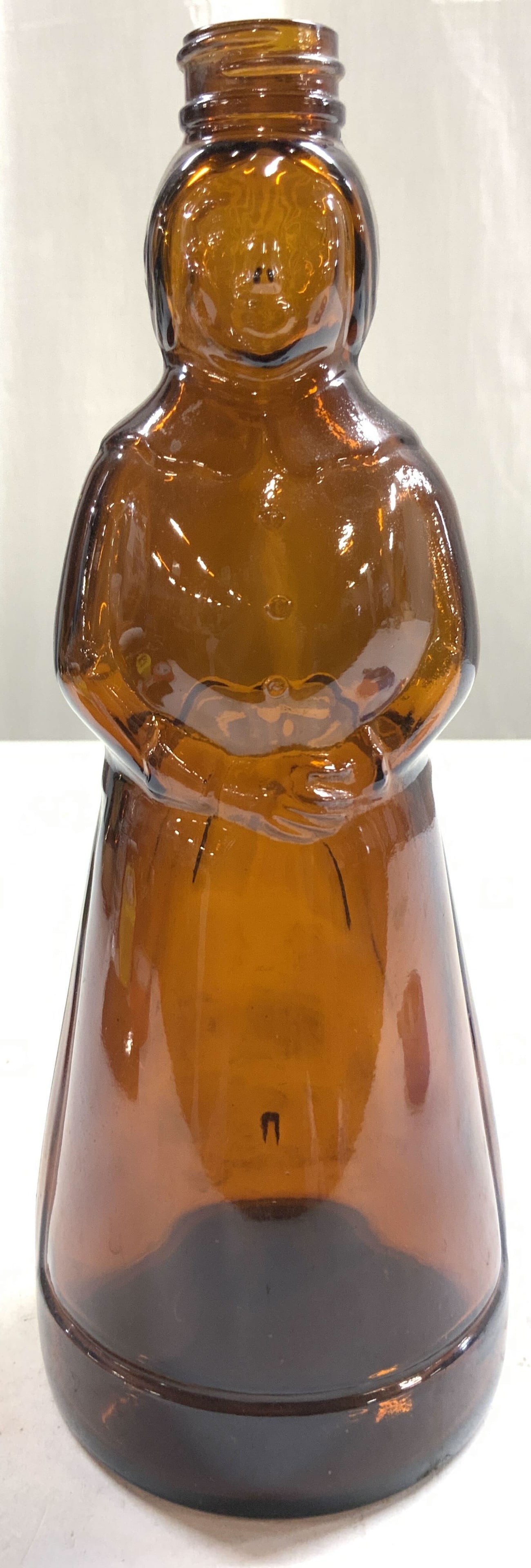 Vintage Glass Mrs Butterworths Syrup Container: Syrup bottle is vintage. Piece is amber toned and glass. Vintage Mrs Butterworths female figure syrup bottle. Vessel measures approximately 10 inches tall 4 inches wide. Syrup container, syrup bottle,