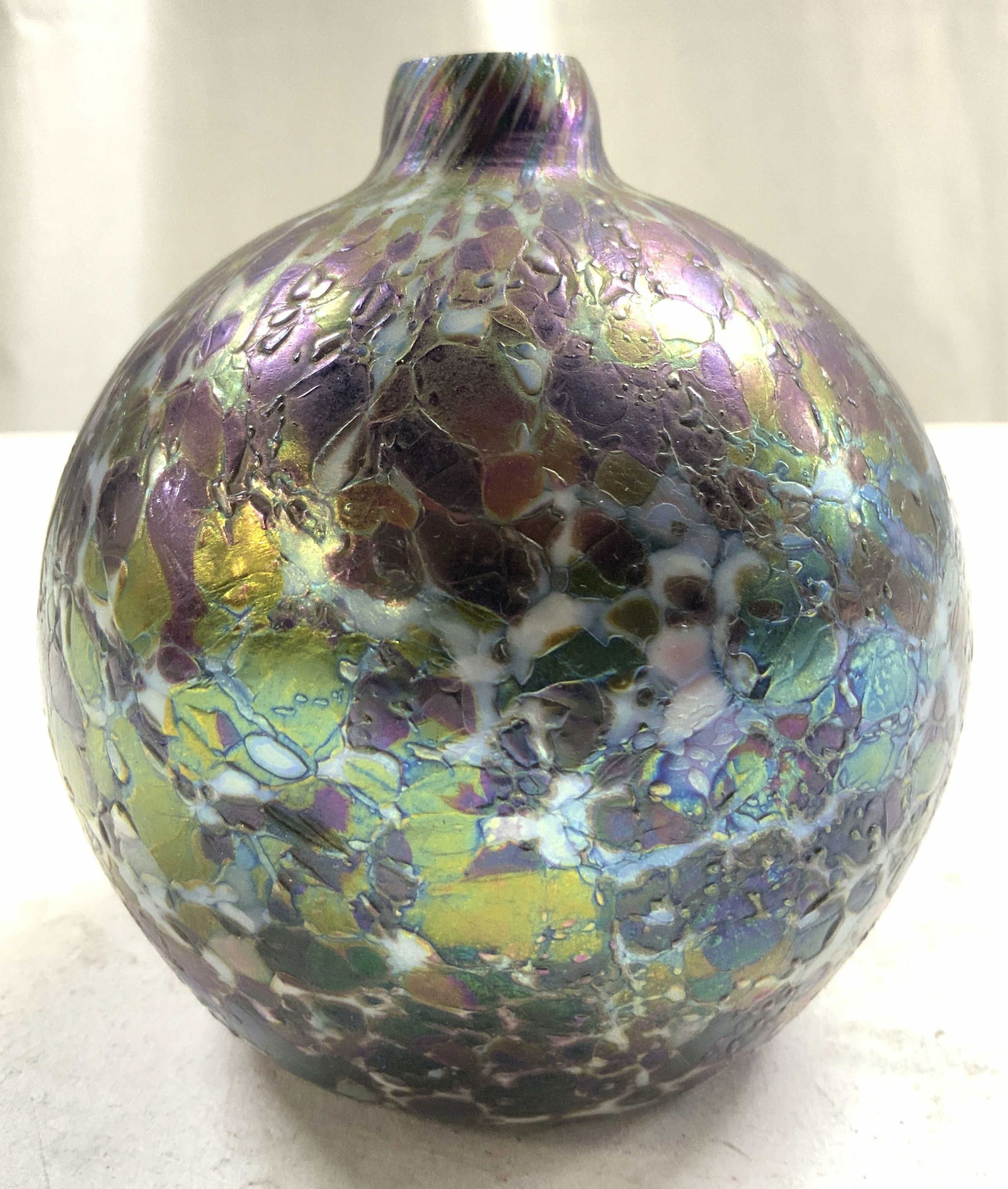 Vintage Textured Iridescent Obsidian Gls Bud Vase: Vase is vintage. Iridescent obsidian glass vessel with green, blue, purple, yellow and white toned detailing. Vessel has small mouth. Possibly hand blown. Vessel measures approximately 4 inches tall 3