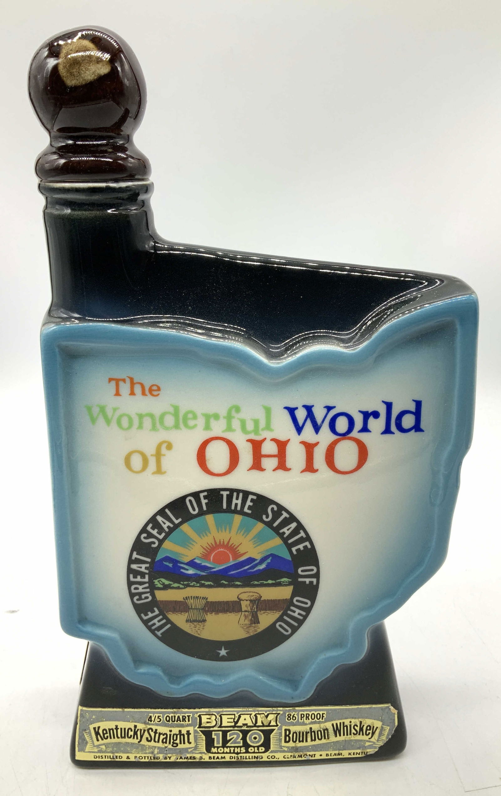 Vntg Hand Crafted Wonderful World of Ohio Decanter: Vntg Hand Crafted Wonderful World of Ohio Decanter Ceramic decanter shaped like the state of Ohio & features a design celebrating The Wonderful World of Ohio. Decanter produced by Regal China for Jame