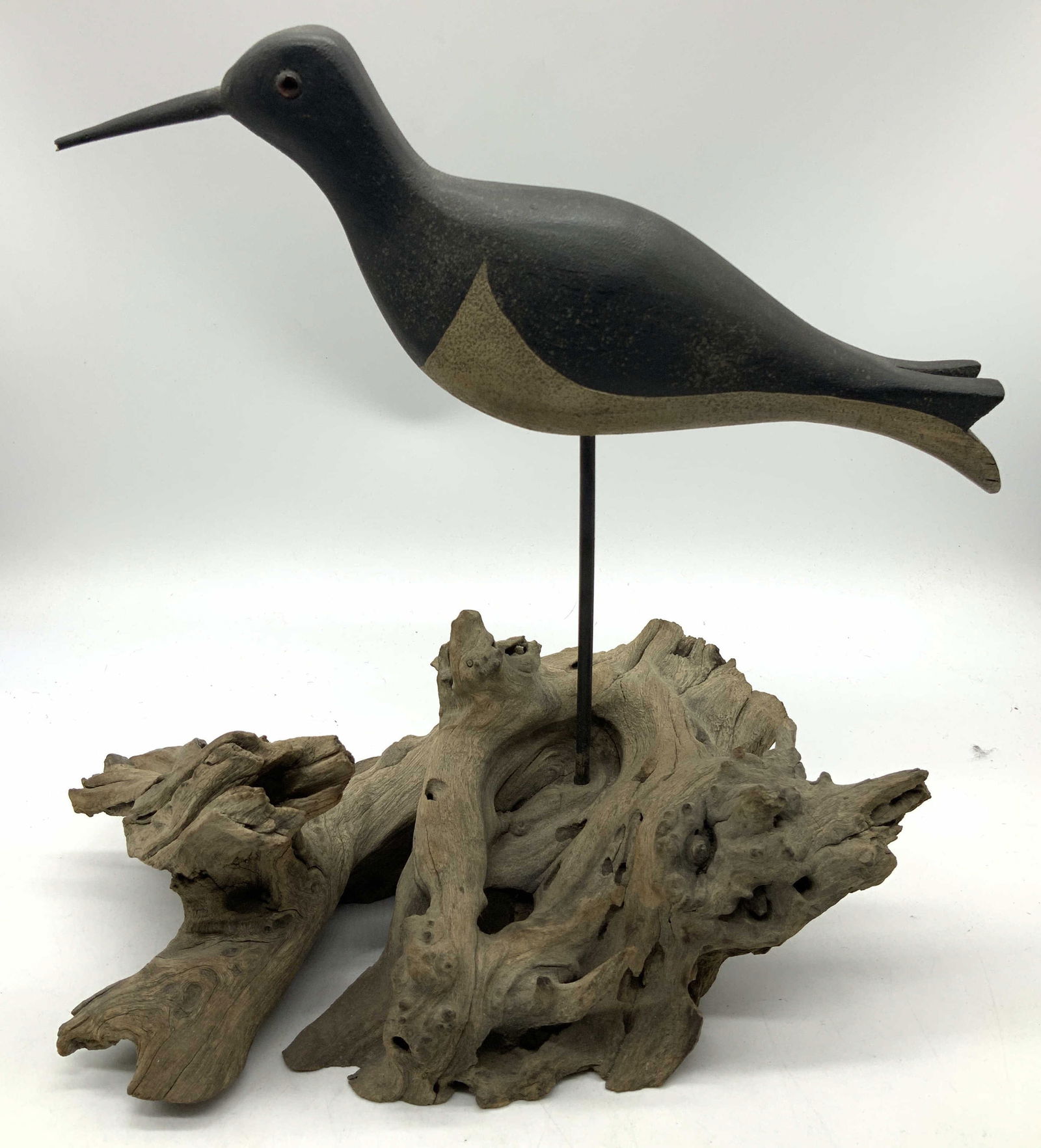 Vntg Folk Art Carved Wooden Shorebird Sculpture: Vntg Folk Art Carved Wooden Shorebird Sculpture Wooden sculpture depicting a shorebird mounted on a piece of driftwood. Sculpture is hand-carved & hand-painted. Surface wear consistent to age, use & e