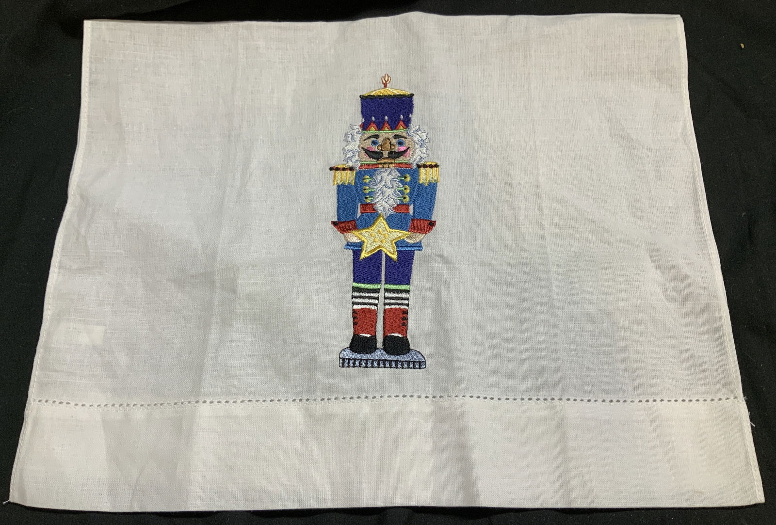 Vntg Linen Embroidered Nutcracker Hand Towel: Vntg Linen Embroidered Nutcracker Hand Towel Hand towel appears to be linen material & features an embroidered traditional nutcracker solider. Surface wear consistent to age, use & exposure. Measureme