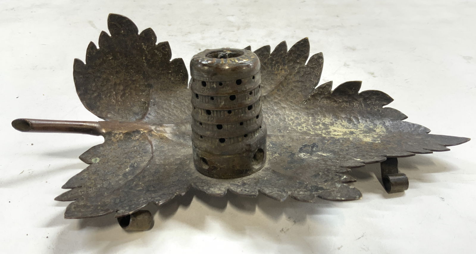 Vintage Gilt Metal Leaf Form Candle Holder: Top of piece inscribed illegibly. Candle holder is vintage. Piece has leaf form with relief to show vascular bundles. Underside is footed. Near center has hive form structure. Leaf form candle holder