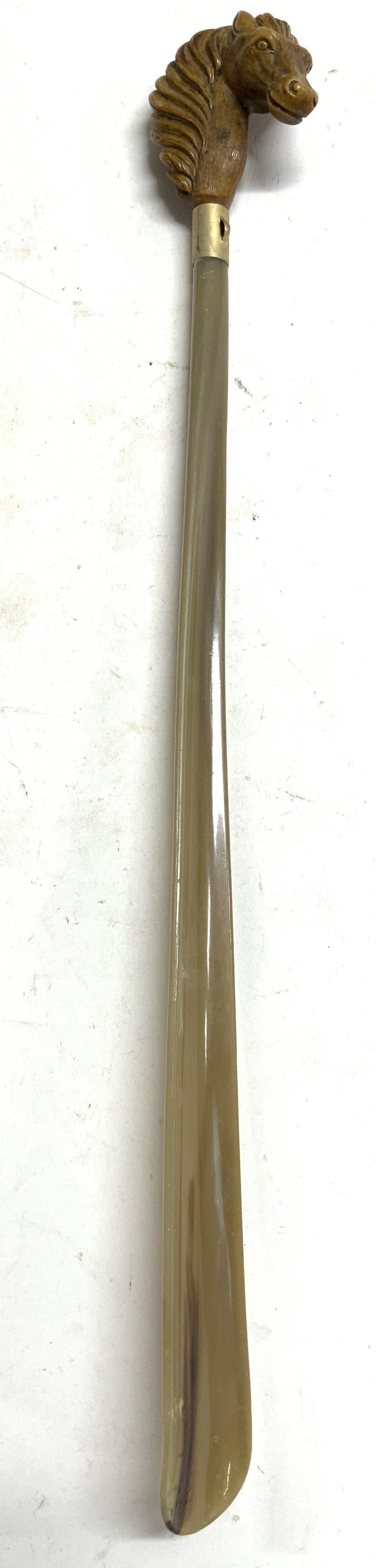 Vntg Bakelite Shoehorn W Wood Horse Handle 19.25in: Shoehorn is Vintage. Piece has carved wooden horse head handle. Shoehorn is Bakelite with tan and brown tones. Shoehorn measures approx 19.25 inches tall 2.5 inches deep. Shoehorn, vintage shoehorn, B