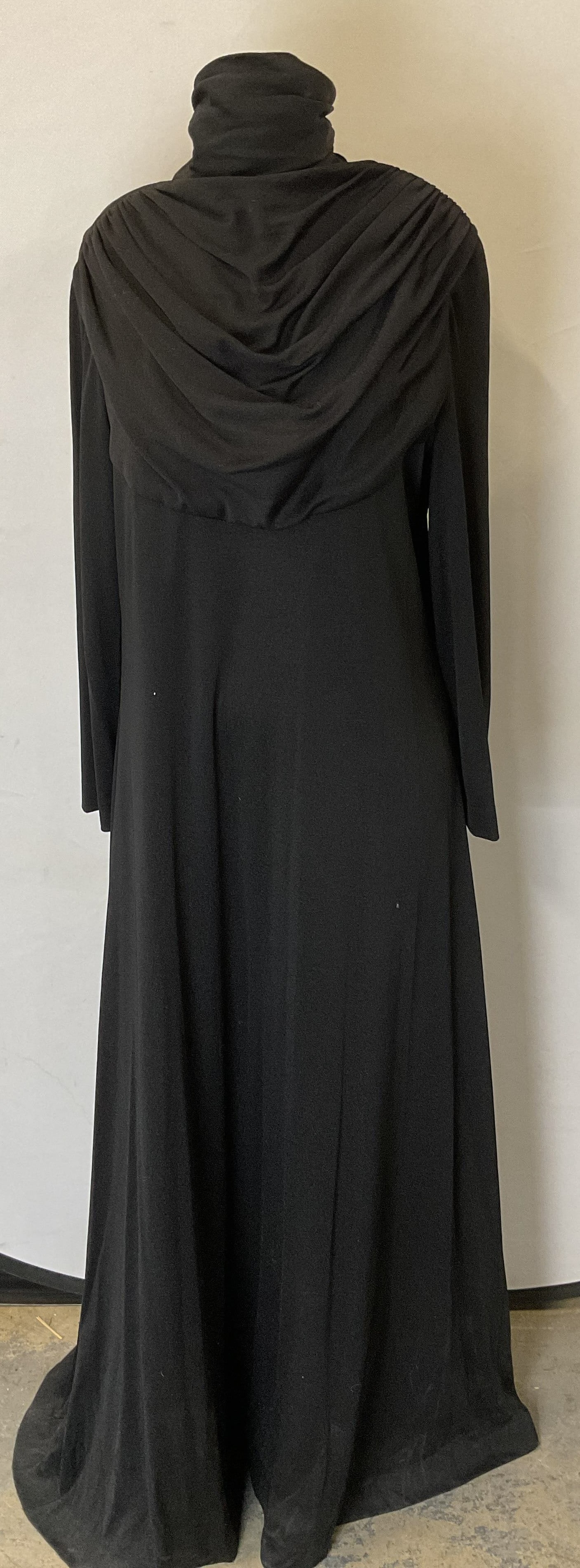 Vintage Bloomingdales Black Maxi Dress: Vintage Bloomingdales long sleeve black maxi dress with pleated chest detail. Measures approx 17 inches across chest. Material feels synthetic, has some stretch. Some blemishes observed. Bloomingdales