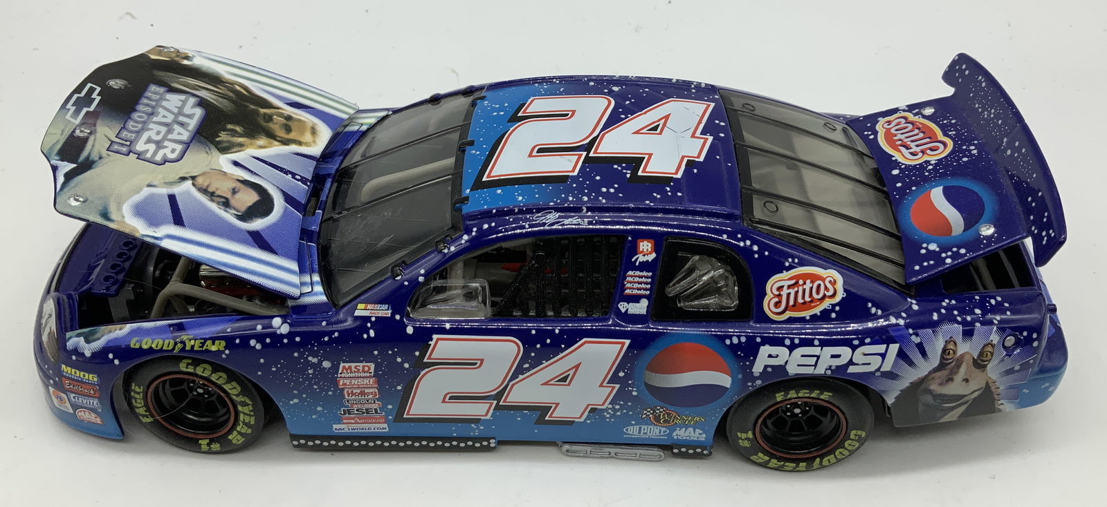 NASCAR 1999 Pepsi/Star Wars #24 Die-Cast Metal Car: NASCAR 1999 Pepsi/Star Wars #24 Die-Cast Metal Car 1:24 die-cast metal replica of limited edition Jeff Gordon 1999 #24 Pepsi/Star Wars Episode 1 NACSAR race car. Car features iconic Pepsi logo & Star 