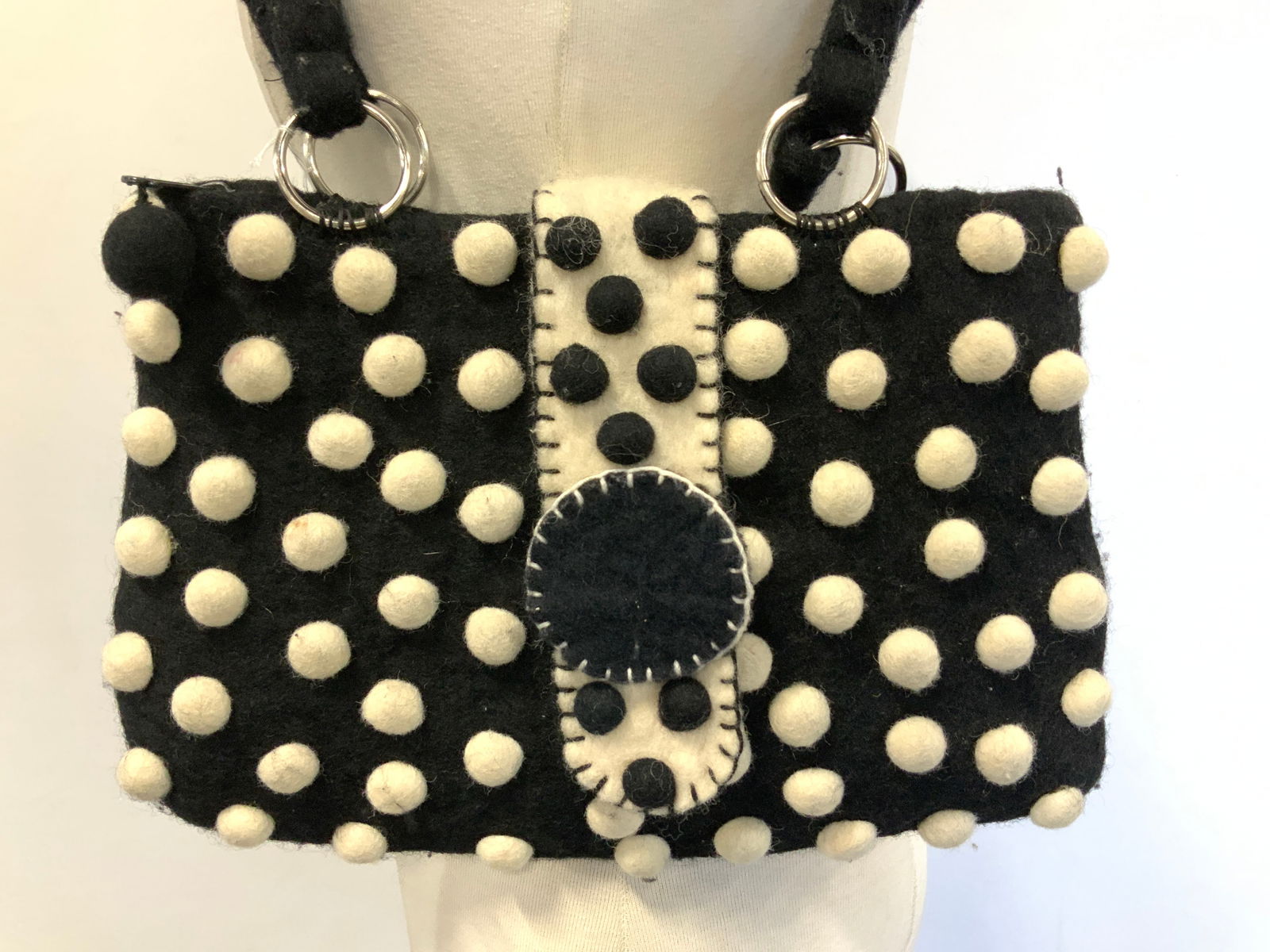 Rising Tide Polkadot Wool Shoulder Bag NEPAL: Rising Tide Polkadot Wool Shoulder Bag NEPAL Shoulder bag featuring a black & white polka dot pattern. Bag has a flap closure & reads, RISING TIDE, 100% WOOL, MADE IN NEPAL. Signed & marked. Surface w