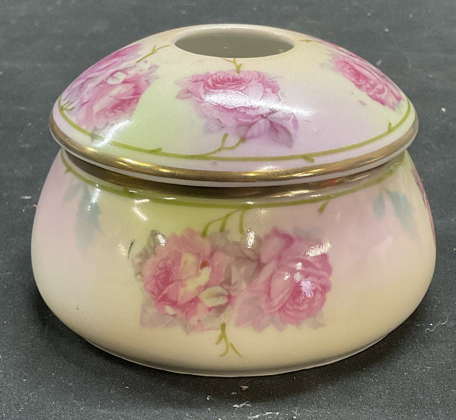 Antique Prince Regent China Hair Receiver Germany: Antique after 1910 Prince Regent China hair receiver. Signed on underside. Made in Germany. Hand painted. Floral motif and gilt decoration. Measures approx 4.25 x 2.75 inches. Some scratching observed