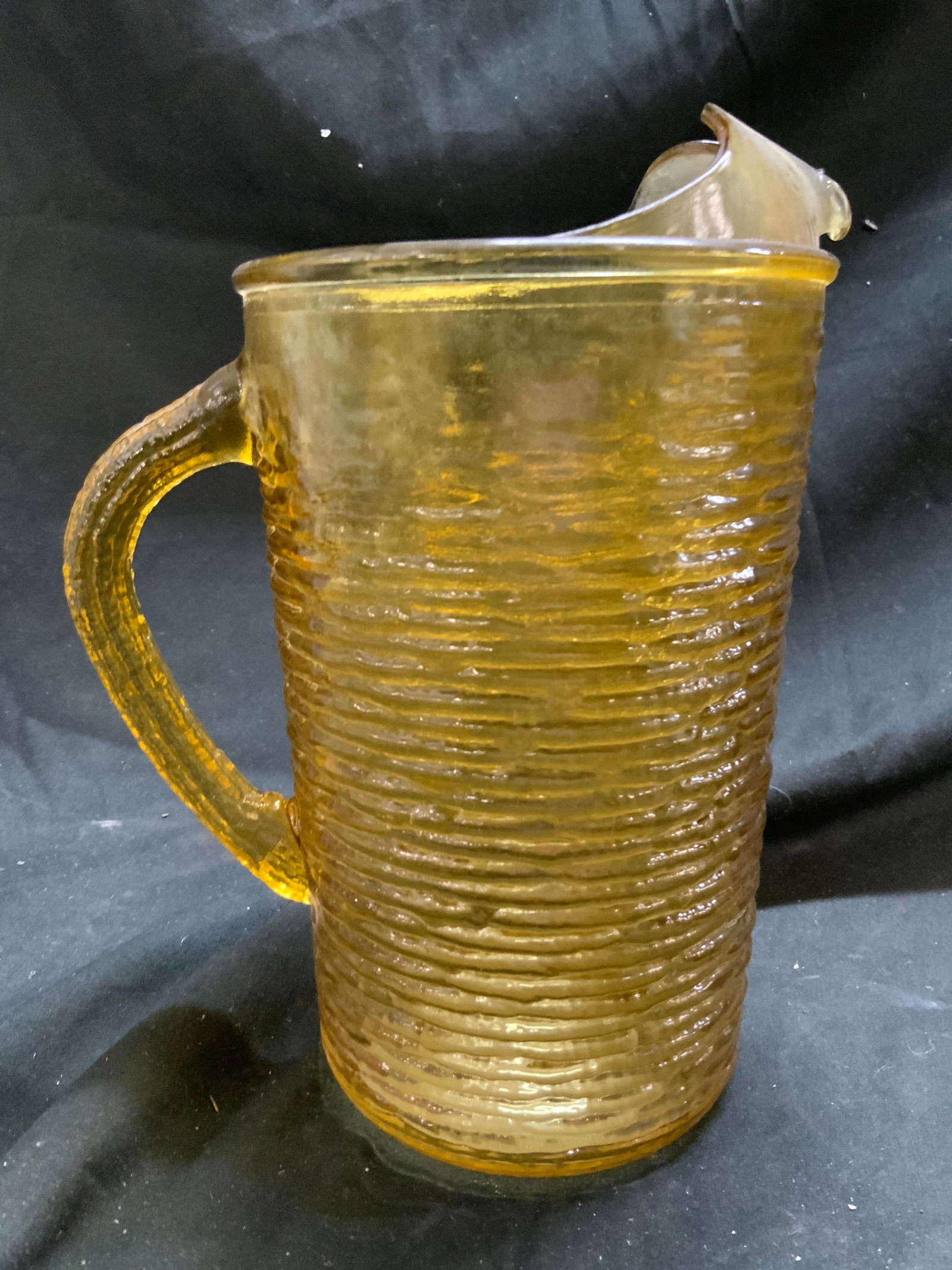 Anchor Hocking Soreno Depression Gls Pitcher: Pitcher appears to be ANCHOR HOCKING (No apparent markings). Pitcher is amber yellow toned. Piece has ribbed relief detail to exterior. Pitcher is vintage. Vessel measures approximately 9.5 inches tal
