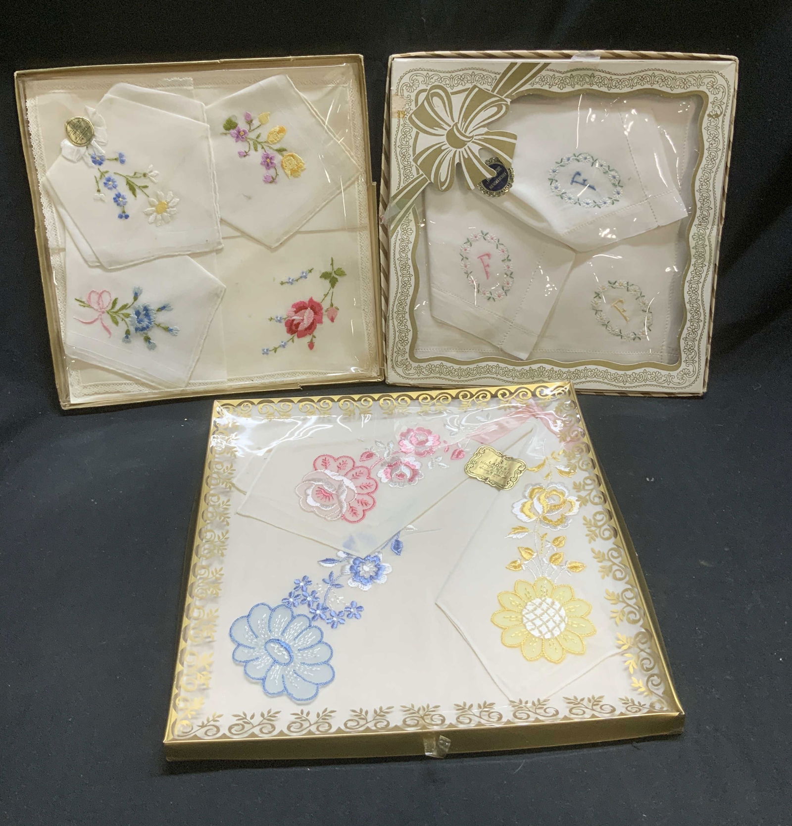Lot 3 Embroid. Floral Handkerchiefs SWITZERLAND NIP: Lot 3 Embroid. Floral Handkerchiefs SWITZERLAND NIP Lot includes 3 NEW IN PLASTIC cotton handkerchiefs. Handkerchiefs feature an embroidered floral pattern. 1 box reads, MADE IN SWITZERLAND. Surface w