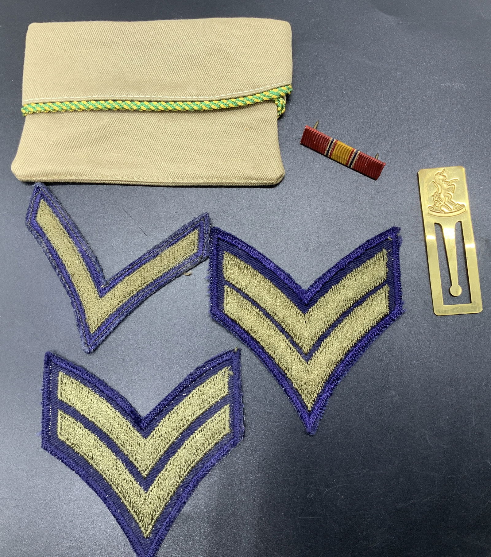 Vntg Circa 1940s Army & National Defense Insignia: Vntg Circa 1940s Army & National Defense Insignia Lot includes, 3 U.S. Army Corporal Chevron patches, 1 National defense service medal ribbon bar & 1 gold tone bone mark that features a carving of a u