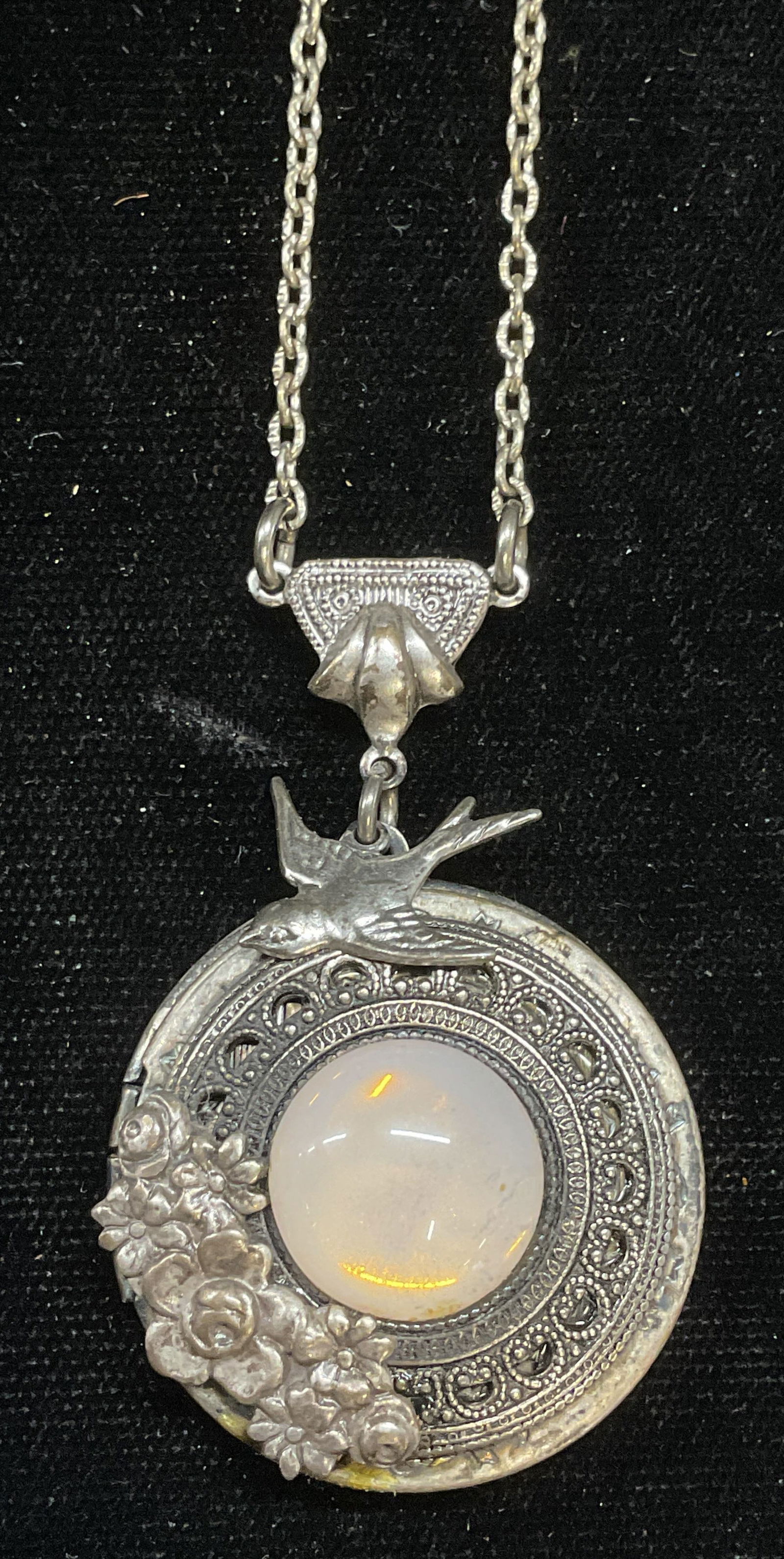 Vtg Silver Pl Faux Moonstone Locket Necklace: Vintage silver plated locket pendant necklace with bird and flower motif and faux lucite moonstone cabochon. Drop length approx 12.5 inches. Locket latch needs repair. Some wear including scratching.