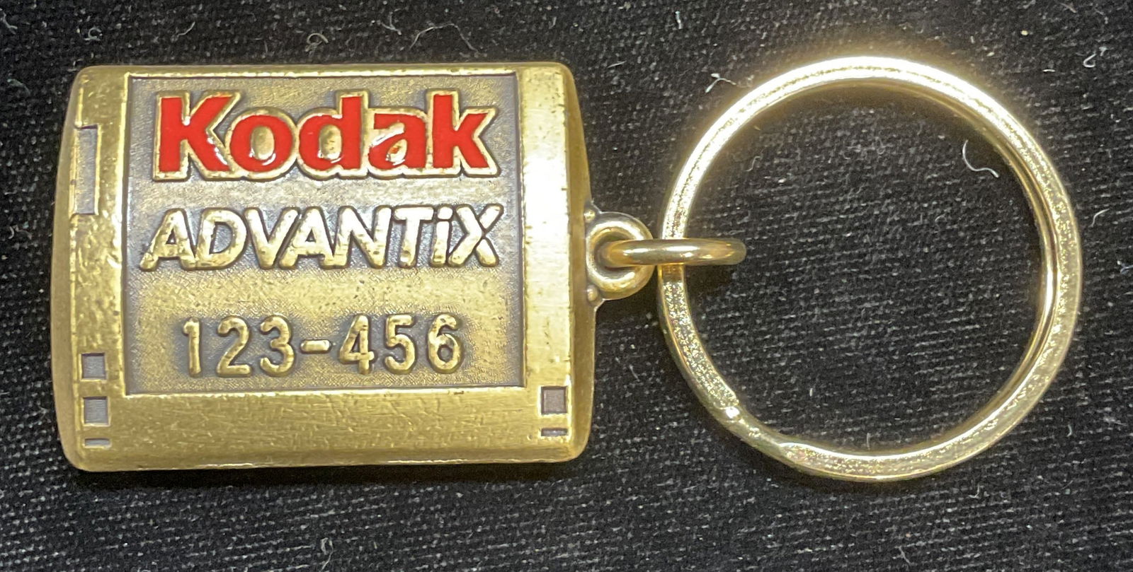 Vintage Kodak Brass Film Roll Keychain: Vintage Kodak brass film roll motif keychain. Measures approx 3.25 x 1.25 inches. Piece has weight. Some scratching. Kodak, Kodak ephemera, Kodak collectibles, Kodak keychain, film roll keychain, came
