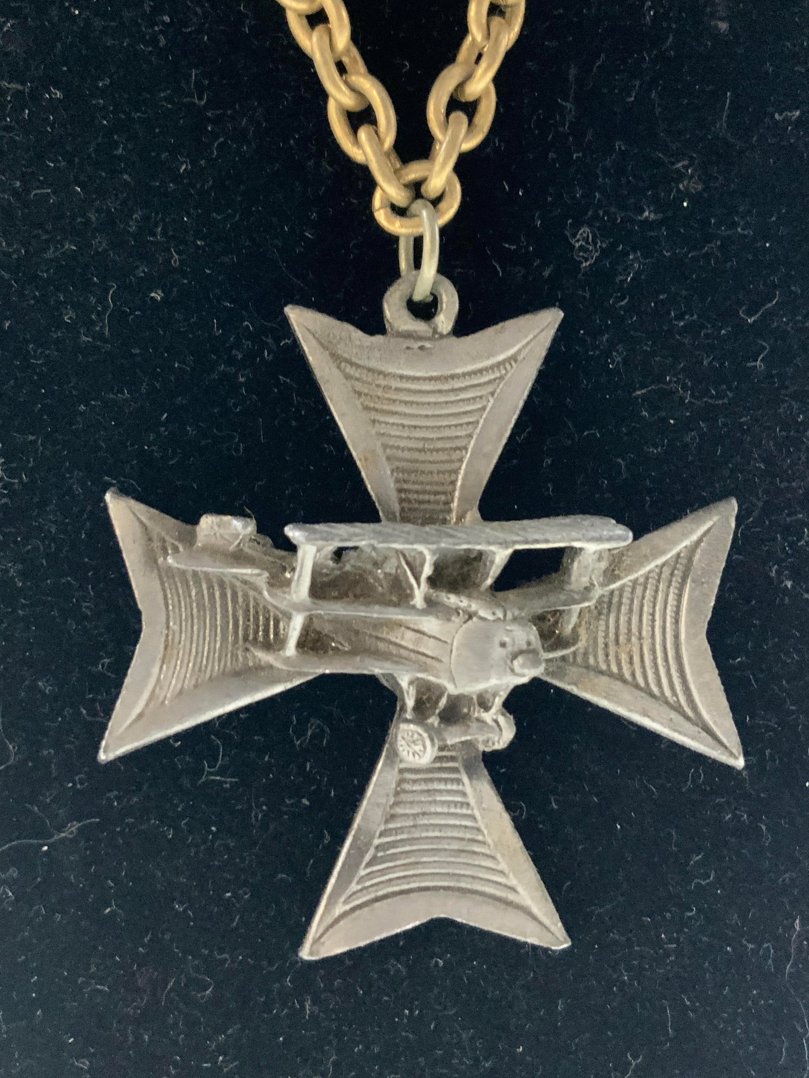 Vtg Maltese Cross Necklace W Airplane Pendant: Necklace is vintage. Piece has gold toned chain link. Pendant has Maltese cross form with airplane in center. Necklace has 11 inches long drop. Pendant measures approximately 2 inches tall and wide. P
