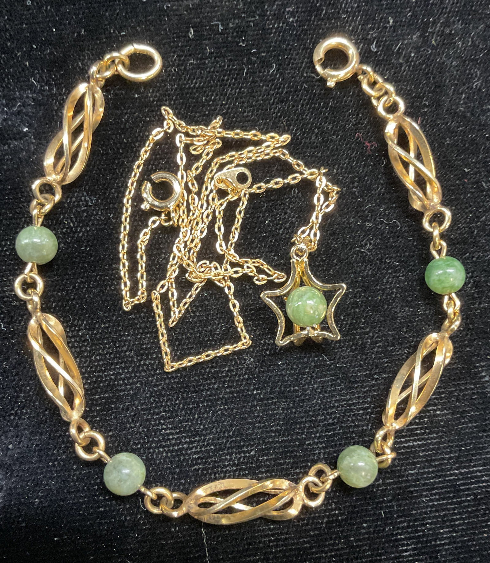 Lot 2 Gold Tn Nephrite Necklace & Bracelet: Lot of 2 vintage gold tone and nephrite pendant necklace and bracelet. Necklace drop length approx 7.5 inches. Bracelet approx 6.5 inches long. Necklace clasp needs repair. Some wear including scratch